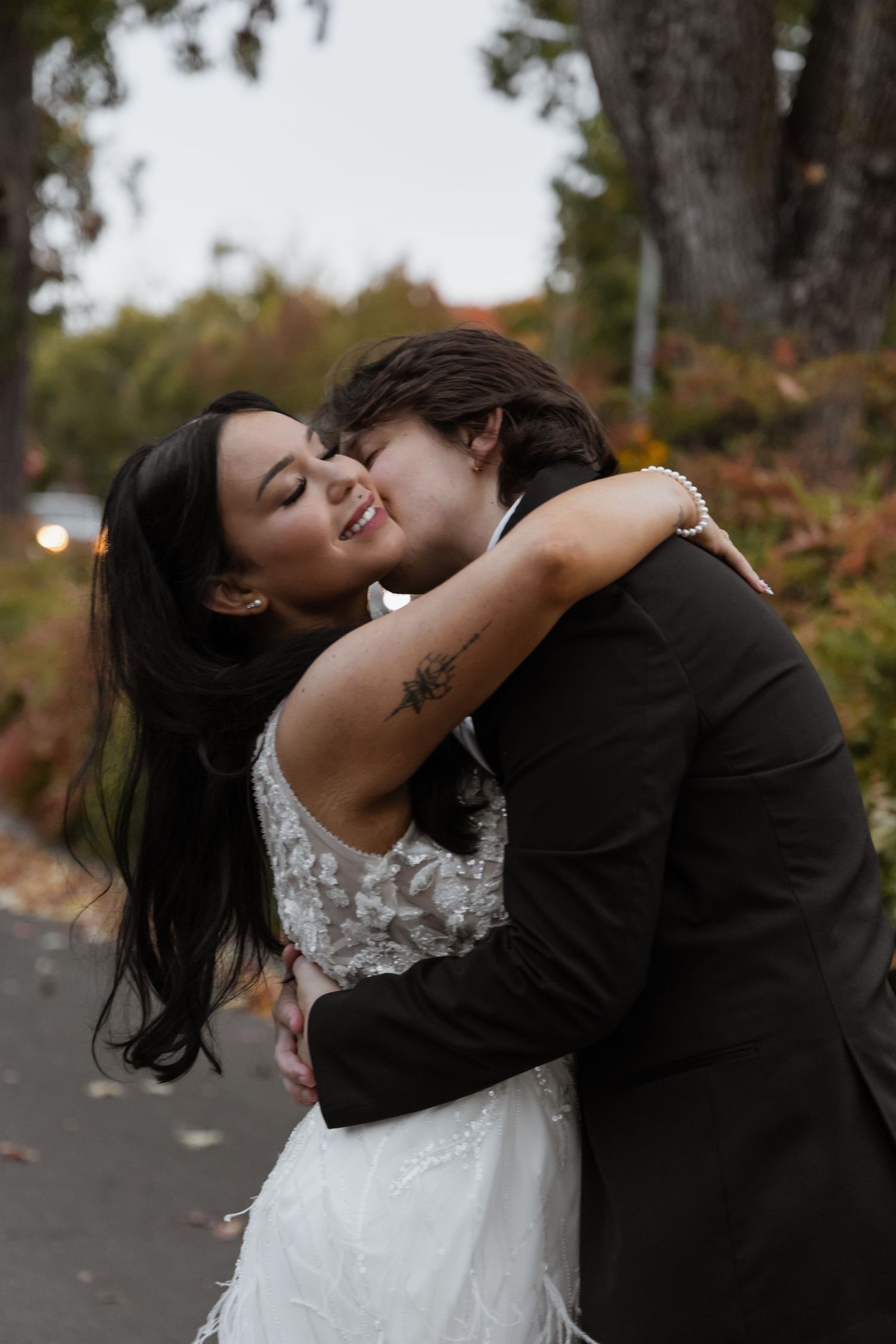 A romantic wedding moment captured outdoors in autumn.