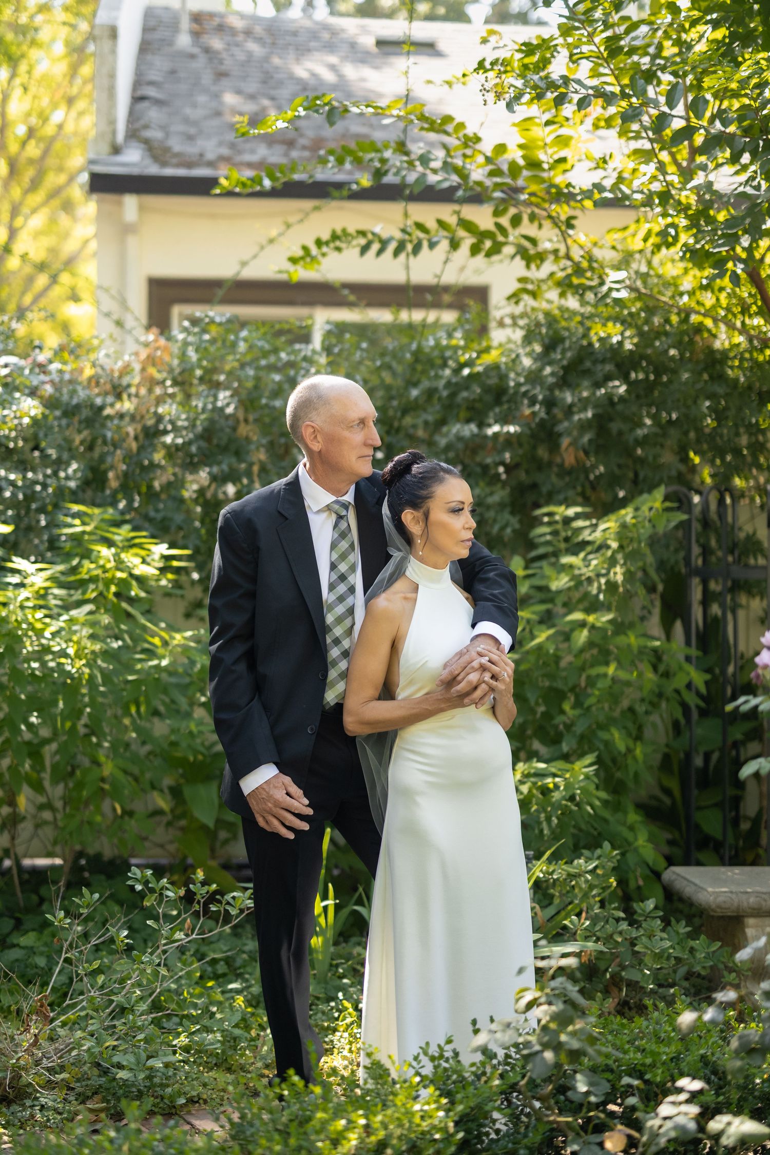 Tender moments between a couple during their garden wedding photoshoot.
