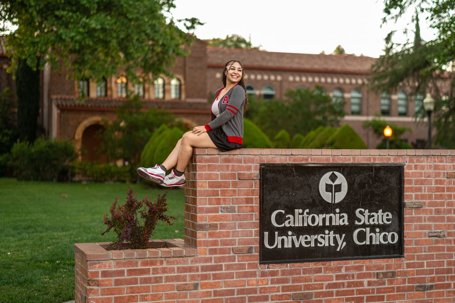 California State University Chico entrance sign with brick wall and landscaping.