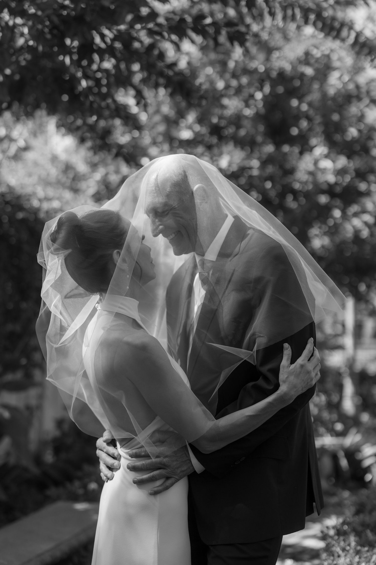 Black and white artistic wedding photos showing silhouettes of a couple in an intimate embrace.