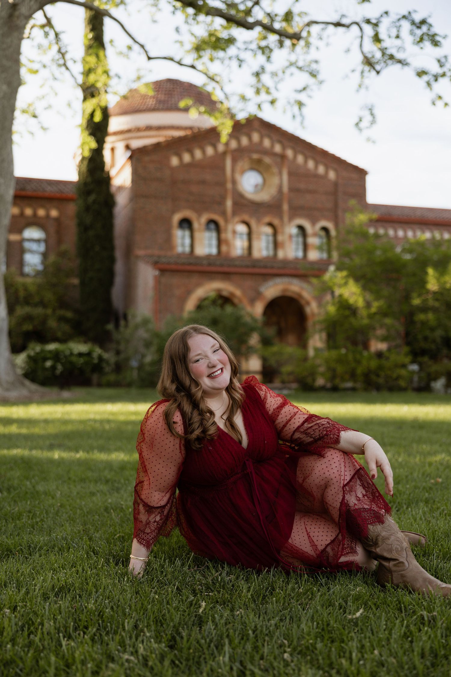 Chico State grad in front of Chico state Kendall hall for graduation photos, by Your Moments by Kelli