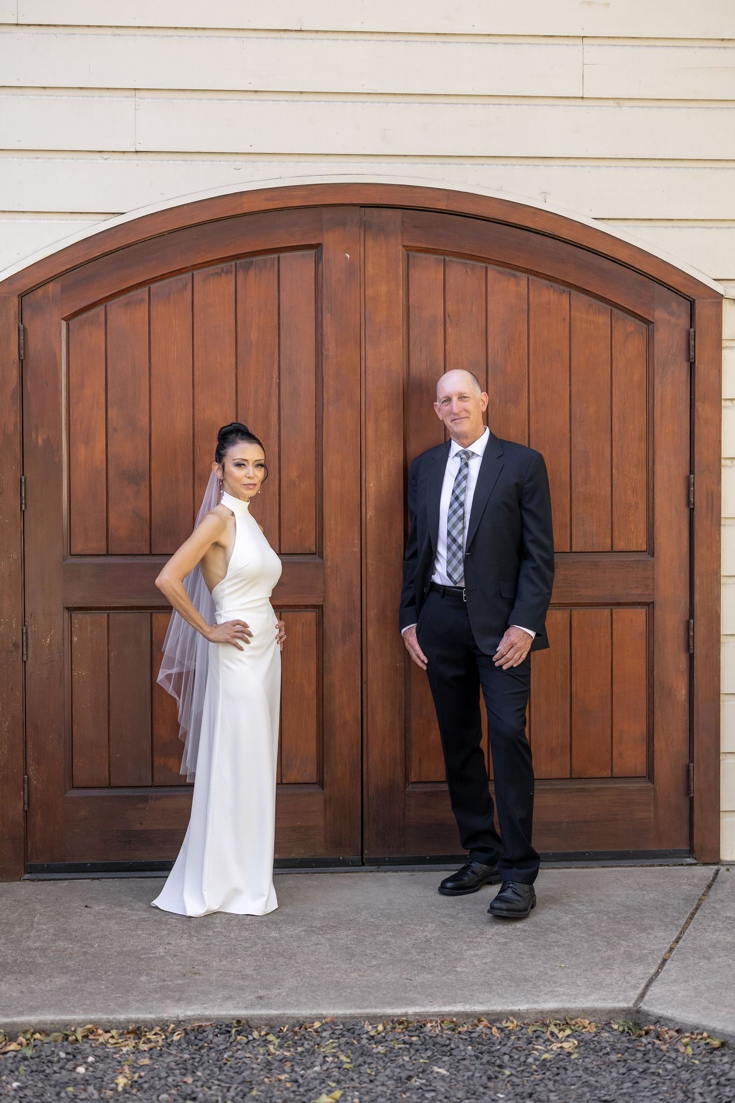 A creative wedding photo sequence against wooden garage doors showing playful interactions.