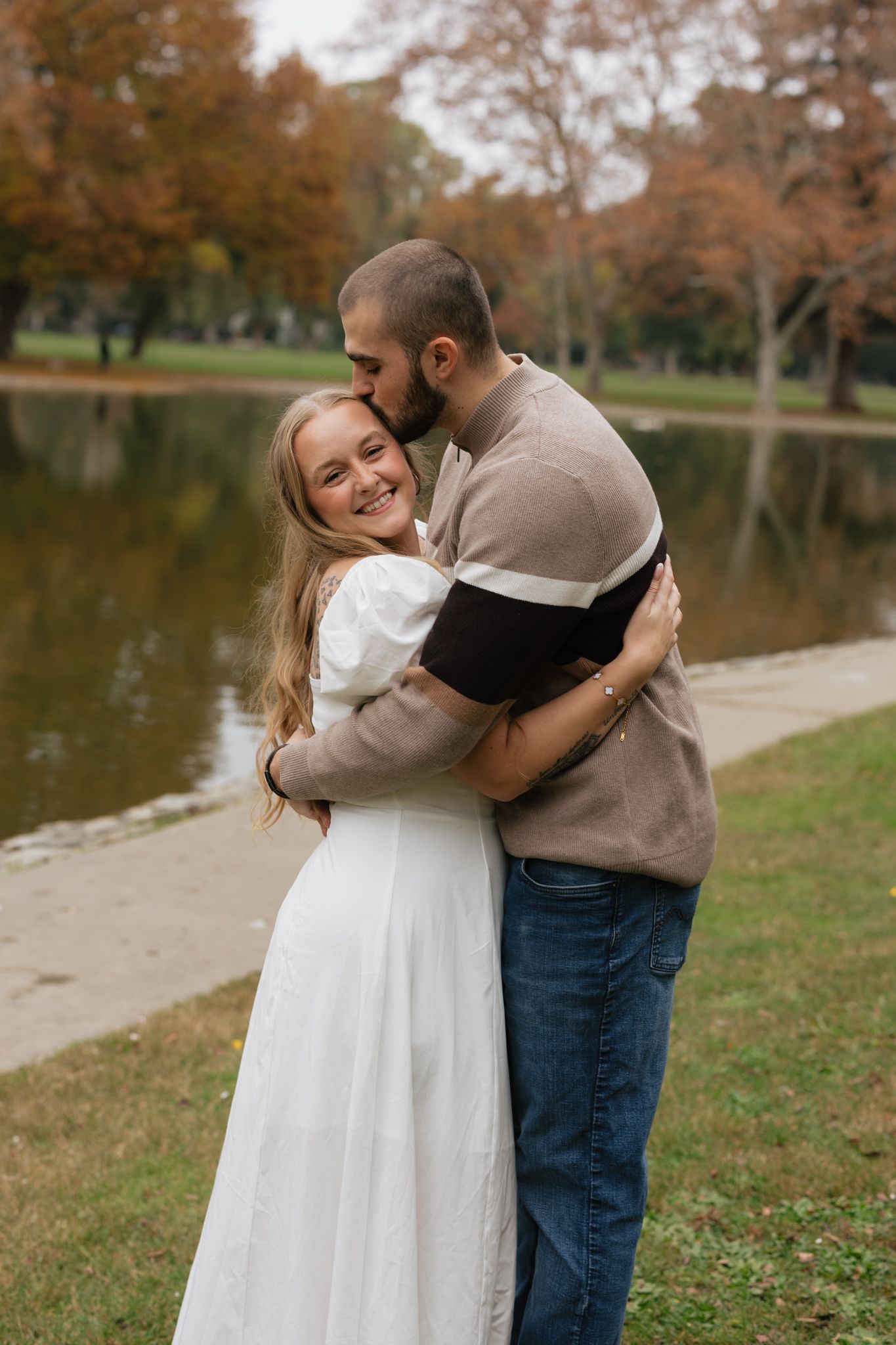 Sweet embraces captured in a series of photos near a lake during fall season.