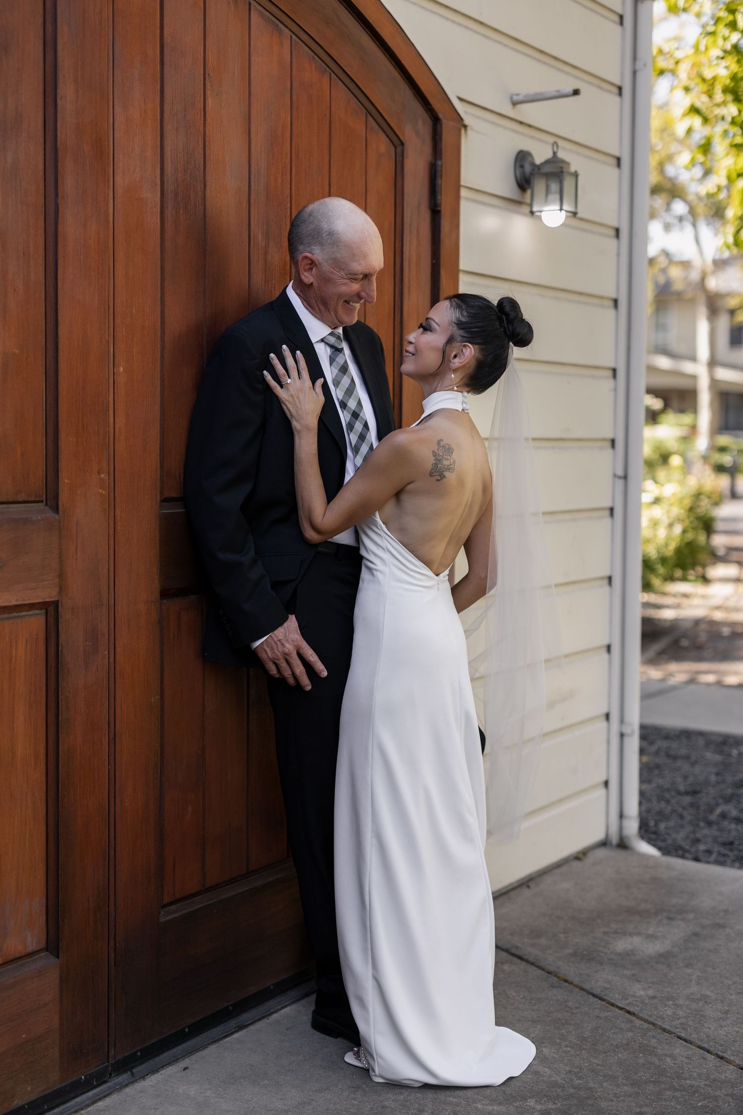 A series of romantic moments captured against a wooden door backdrop.