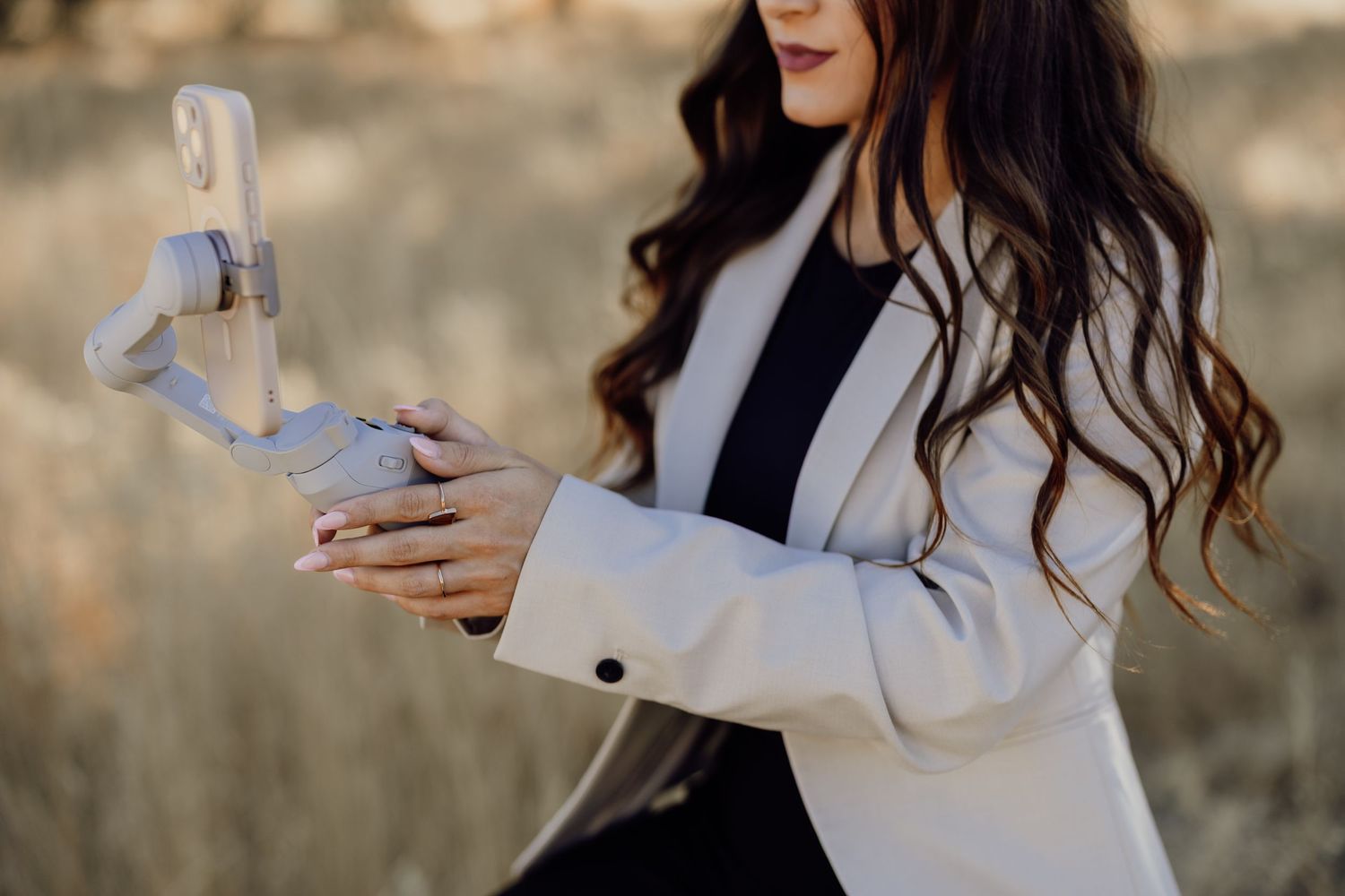 A white blazer outfit photographed against a natural outdoor background.