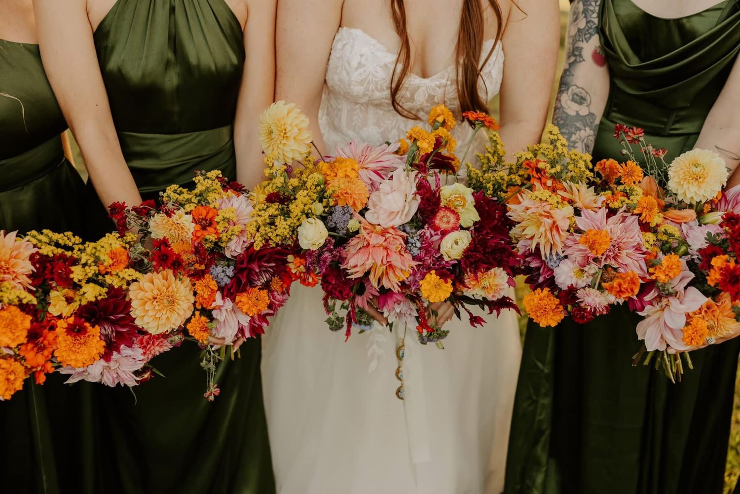 Wedding party floral arrangements in warm autumn colors displayed in a row.