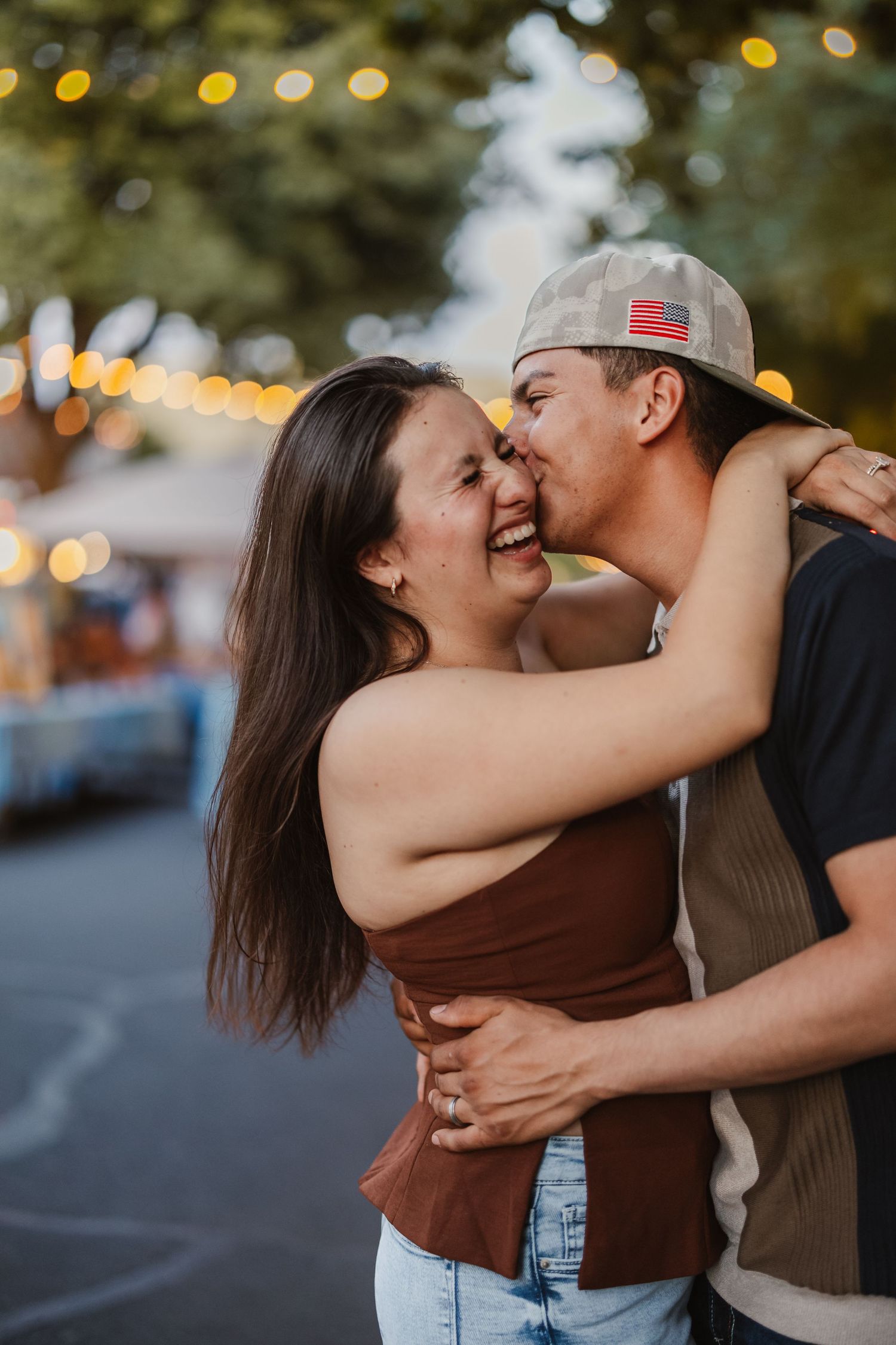 A romantic couple sharing tender moments together outdoors at sunset.
