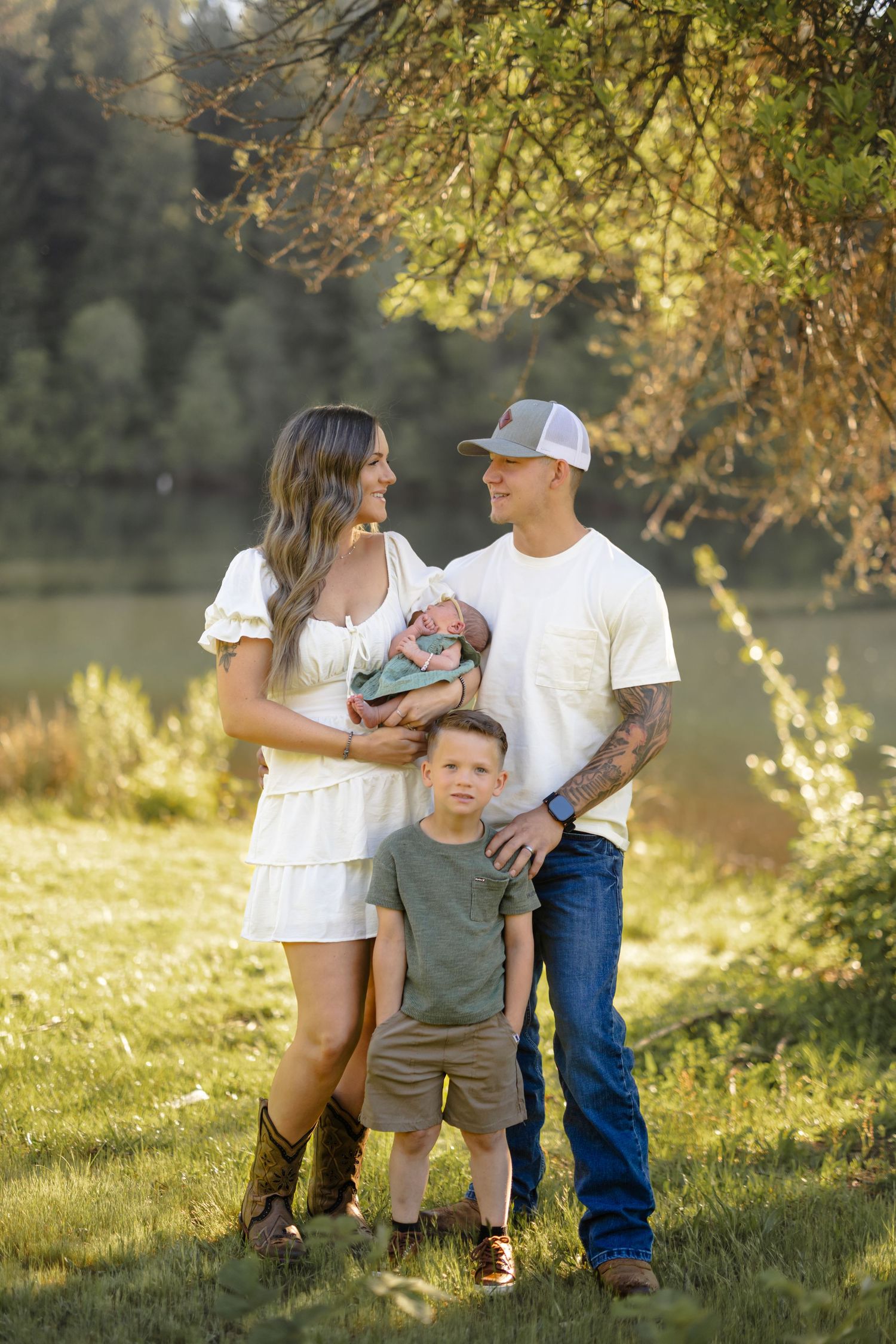 A candid family moment captured in a sunlit meadow during golden hour.
