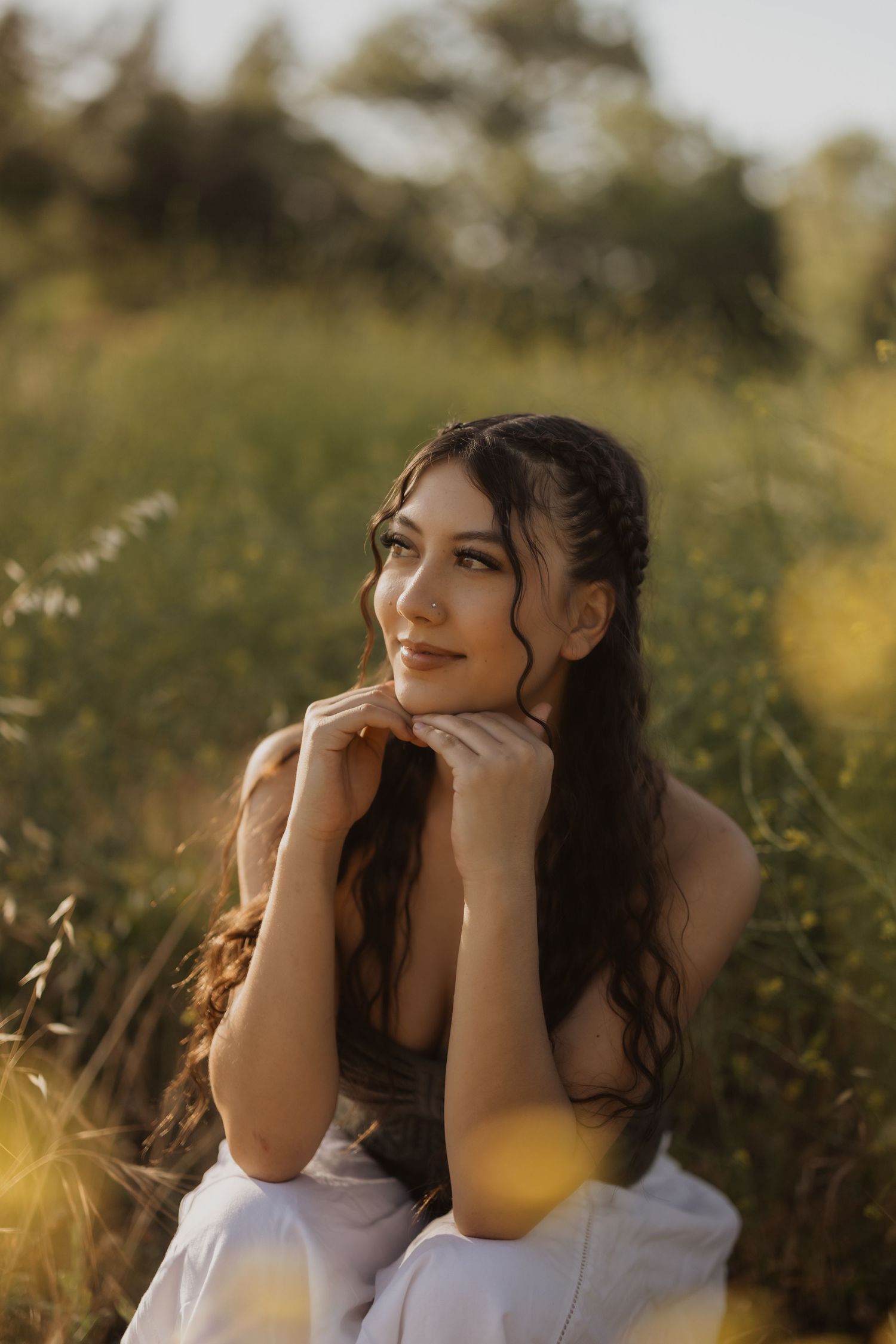 Portrait in golden sunlit field with dreamy summer atmosphere.