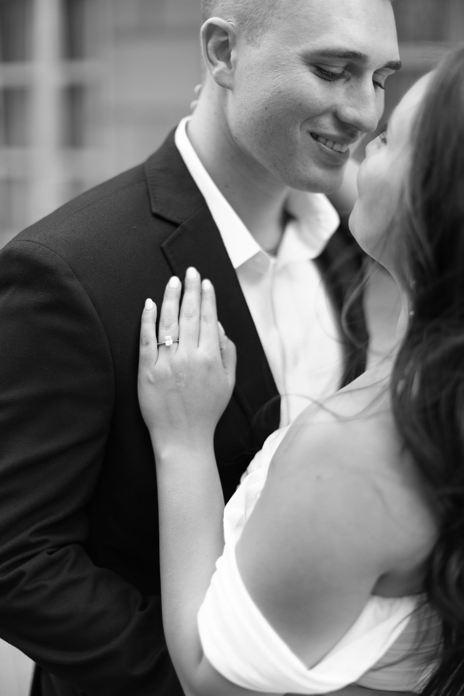 A romantic black and white photo series showing tender moments between a couple in formal wedding attire. Dallas TX