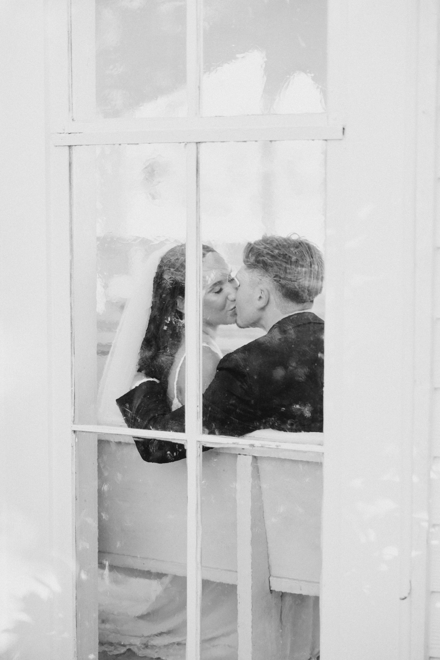Black and white photograph showing silhouettes through window panes in a minimalist architectural setting. Chandelier Farms Terrell TX