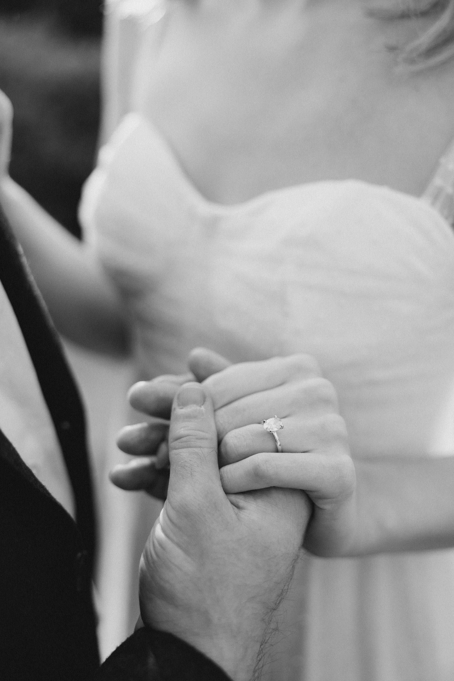 Black and white close-up photos showing hands with wedding rings in a sequence of romantic gestures. Dallas Arboretum Engagement photos.