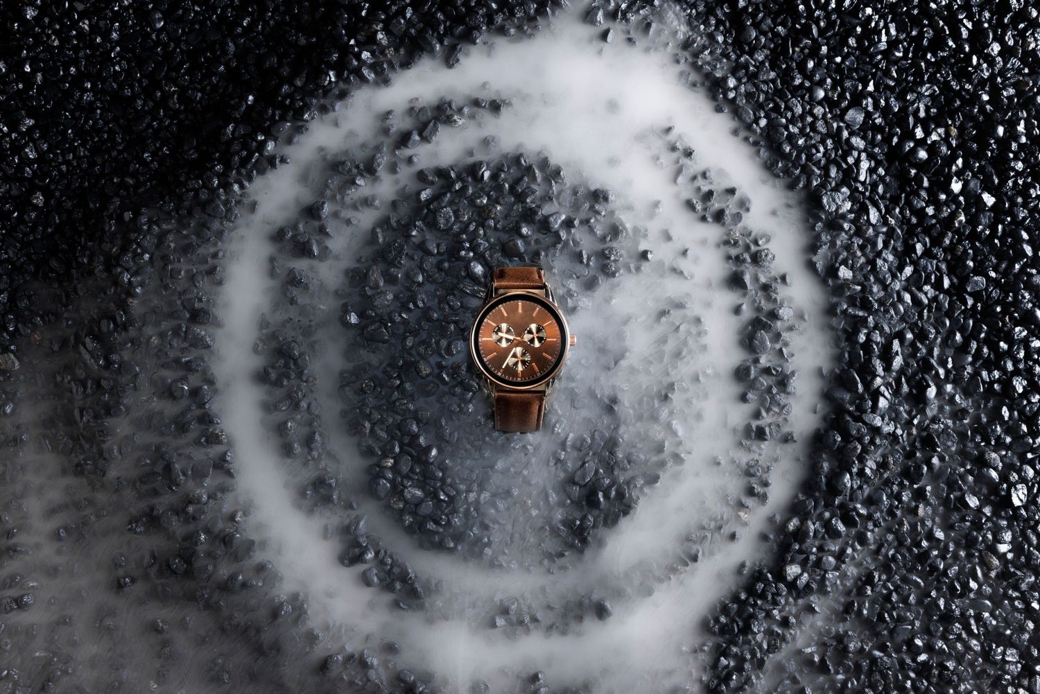 Abstract black and white circular patterns creating a mesmerizing spiral effect against a dark background.