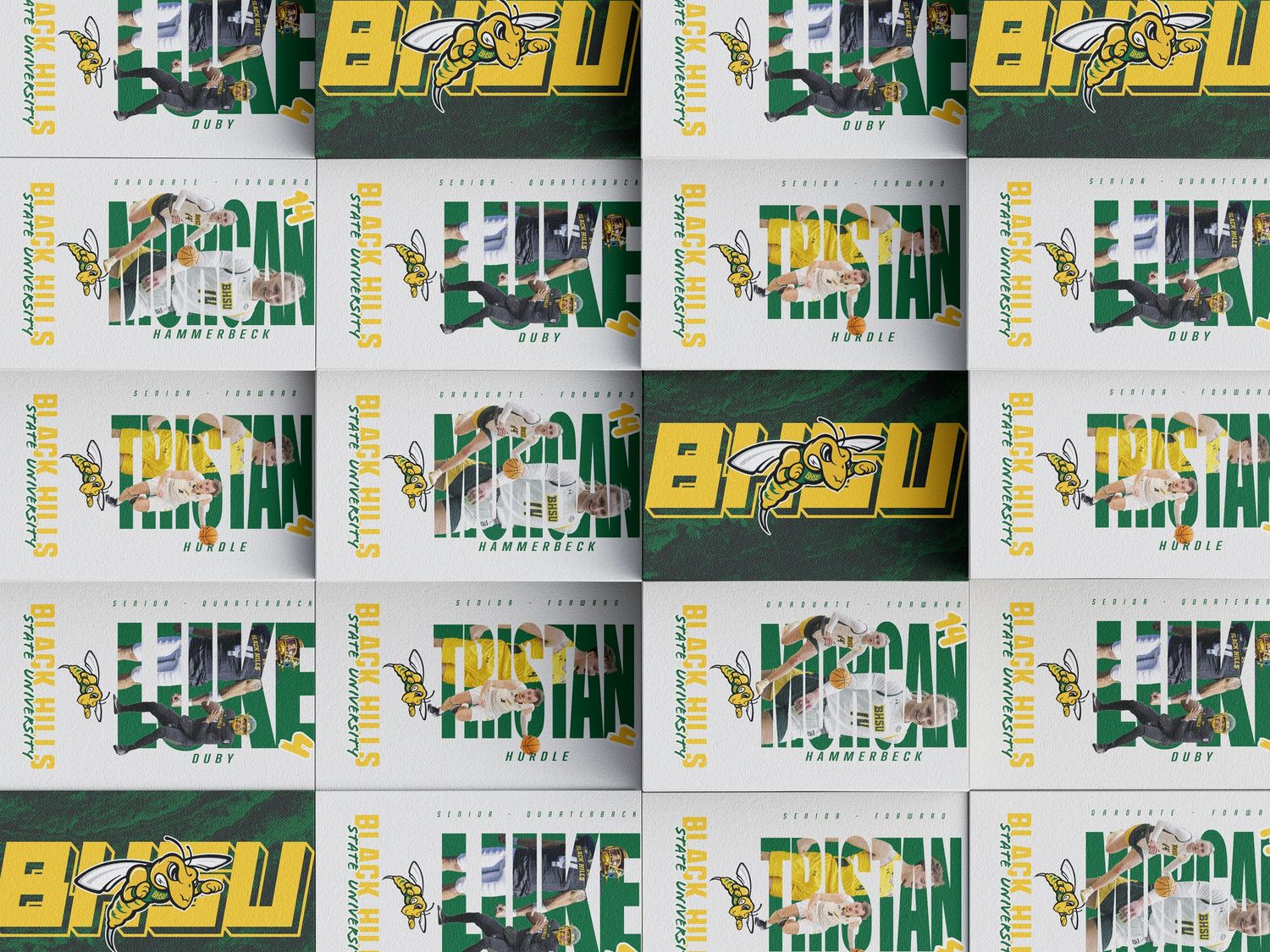 Repeating pattern of yellow and green text logos with 'BASU' text arranged in a grid-like layout against a dark background.
