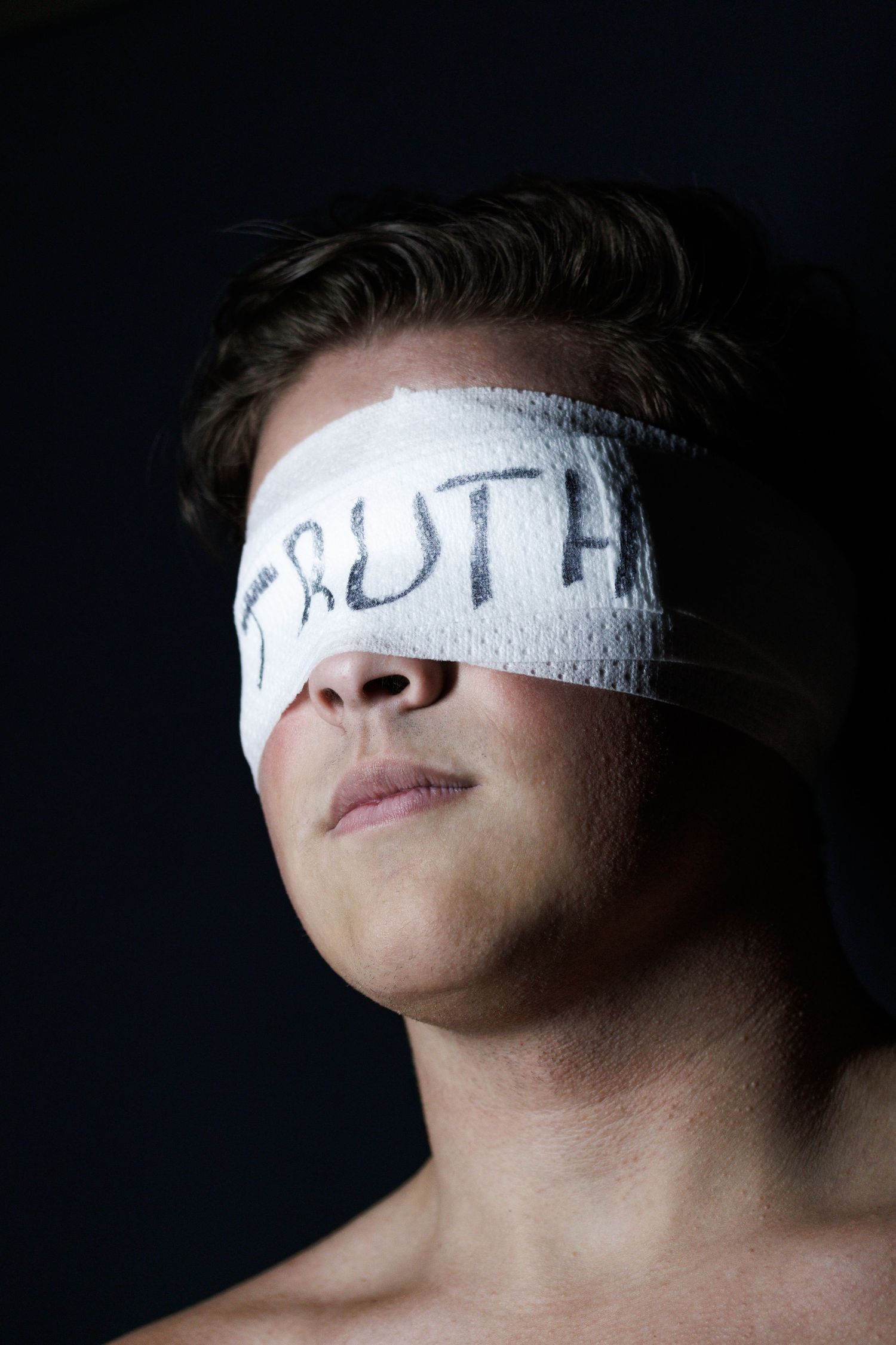 Close-up series of a person wearing white bandages across their eyes against dark background.