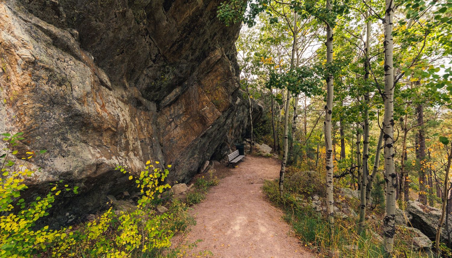 Hiking trail winding through rocky outcroppings and autumn foliage.