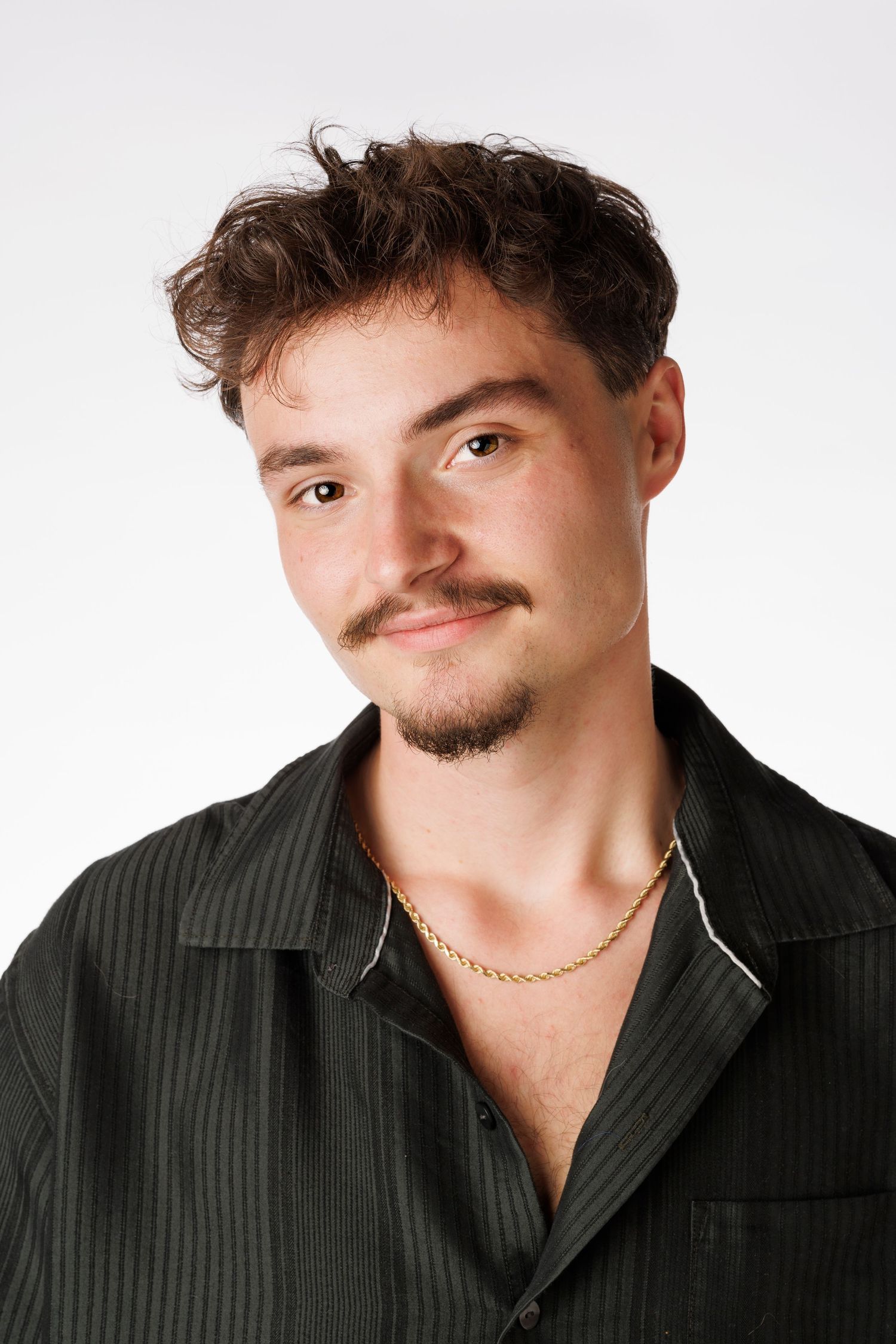 Studio portraits showing different angles of a person wearing a black striped shirt.
