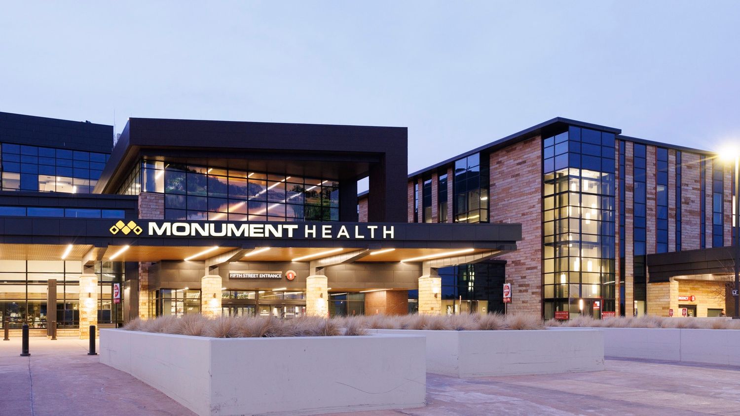 Modern healthcare facility exterior showing Monument Health building at different angles.