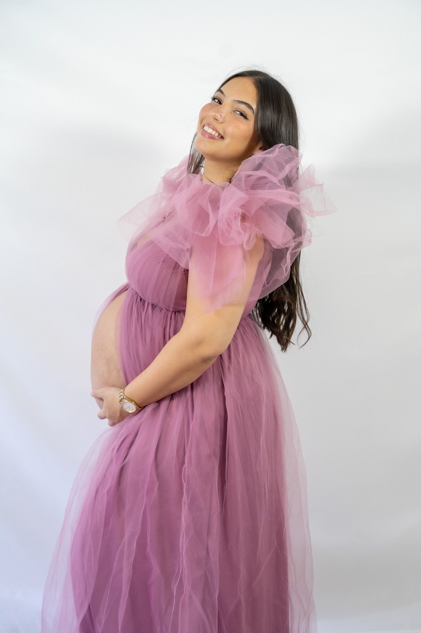 A model in a flowing mauve tulle dress poses gracefully against a white backdrop in a four-panel photo series.
