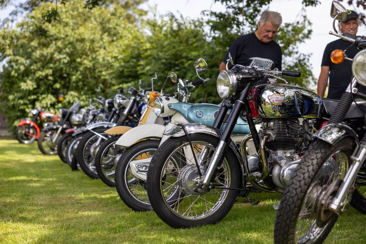 A line up of classic motorcycles at a show in Colchester