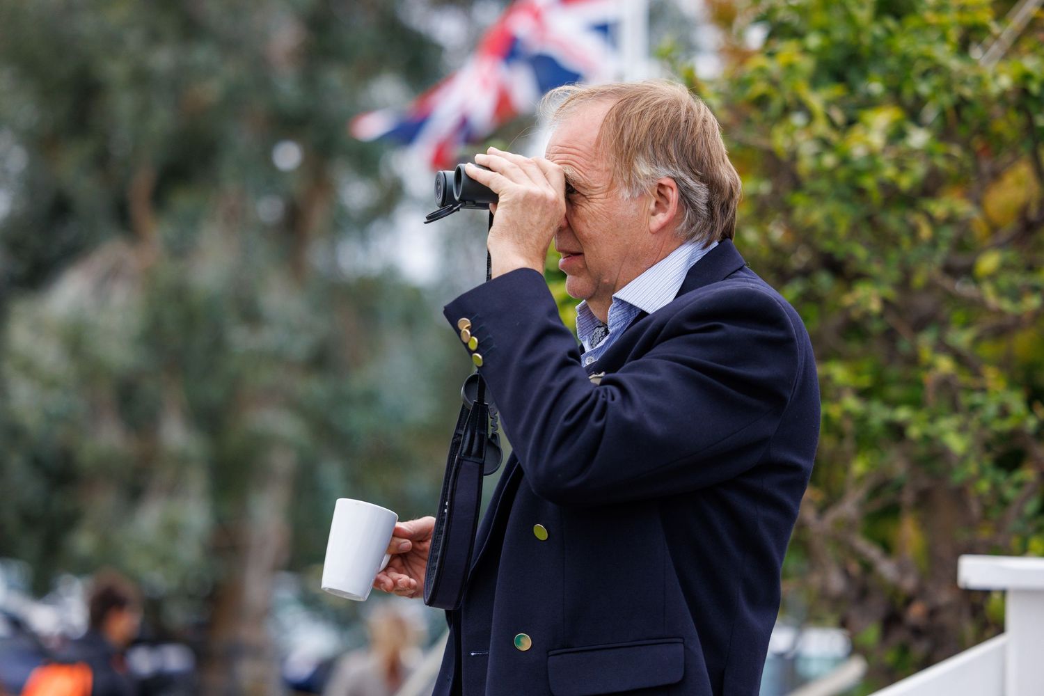 A gentleman using binoculars to view the action at Ham Polo Club