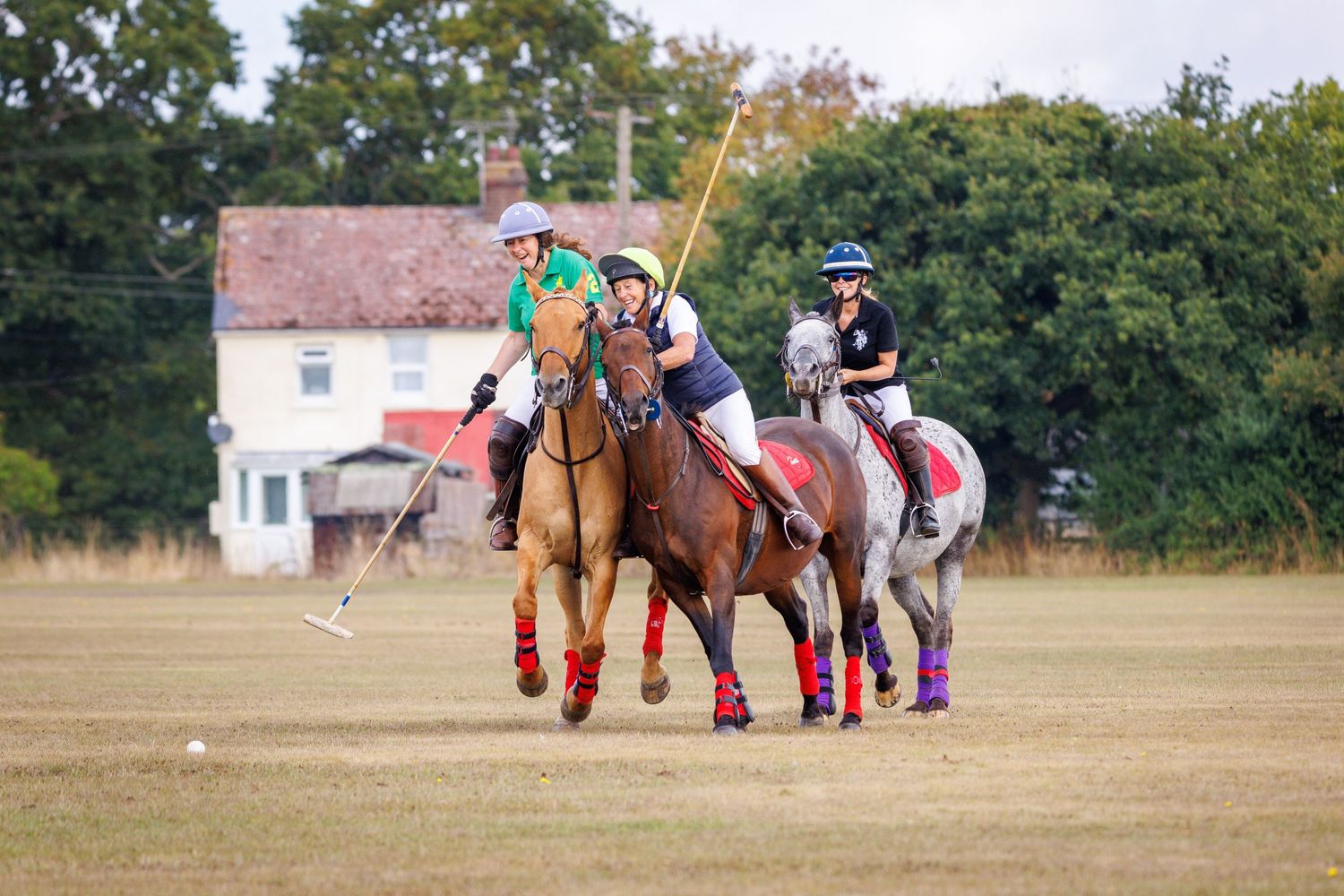 Three people playing polo