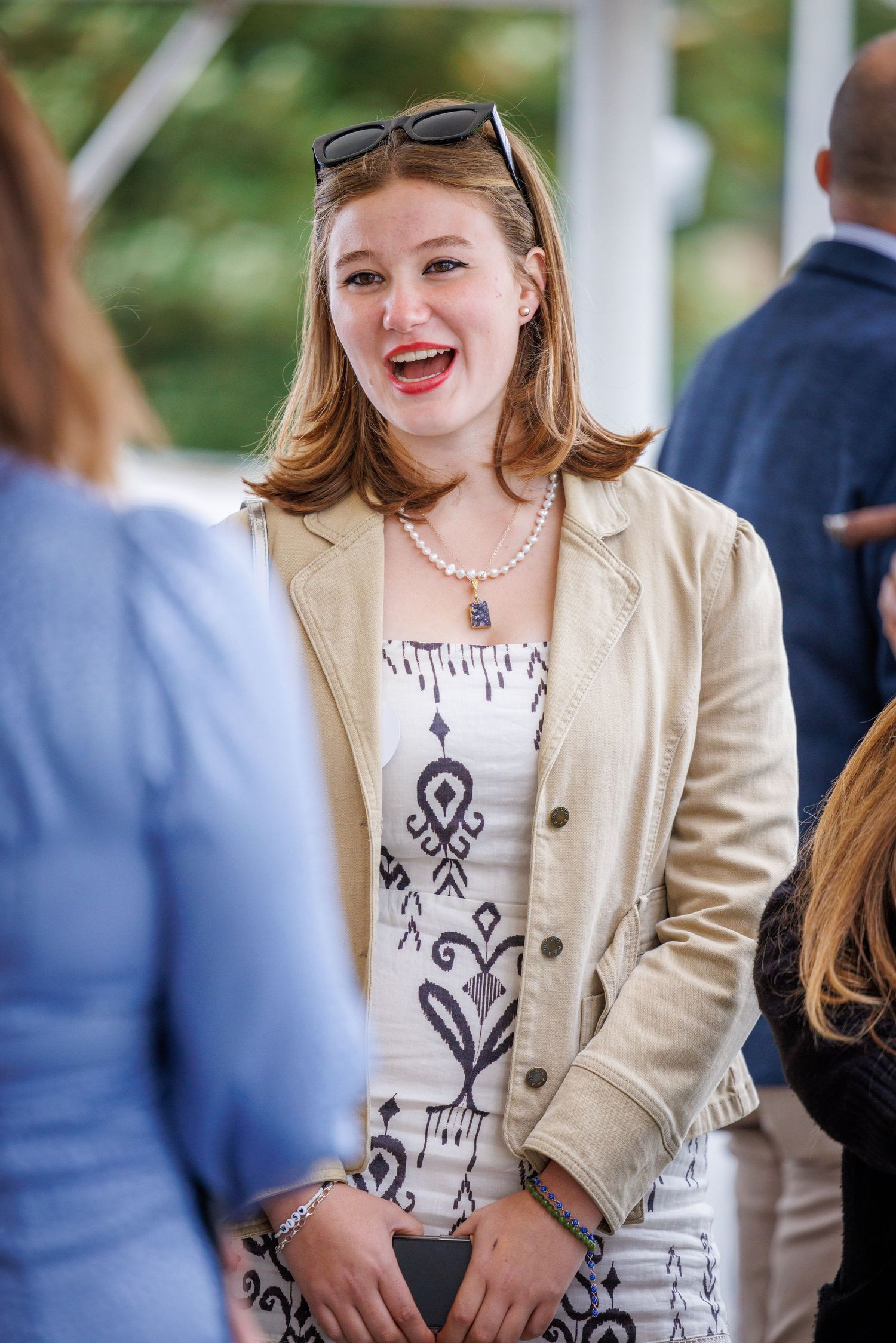 A candid portrait of a woman laughing at Ham Polo Club
