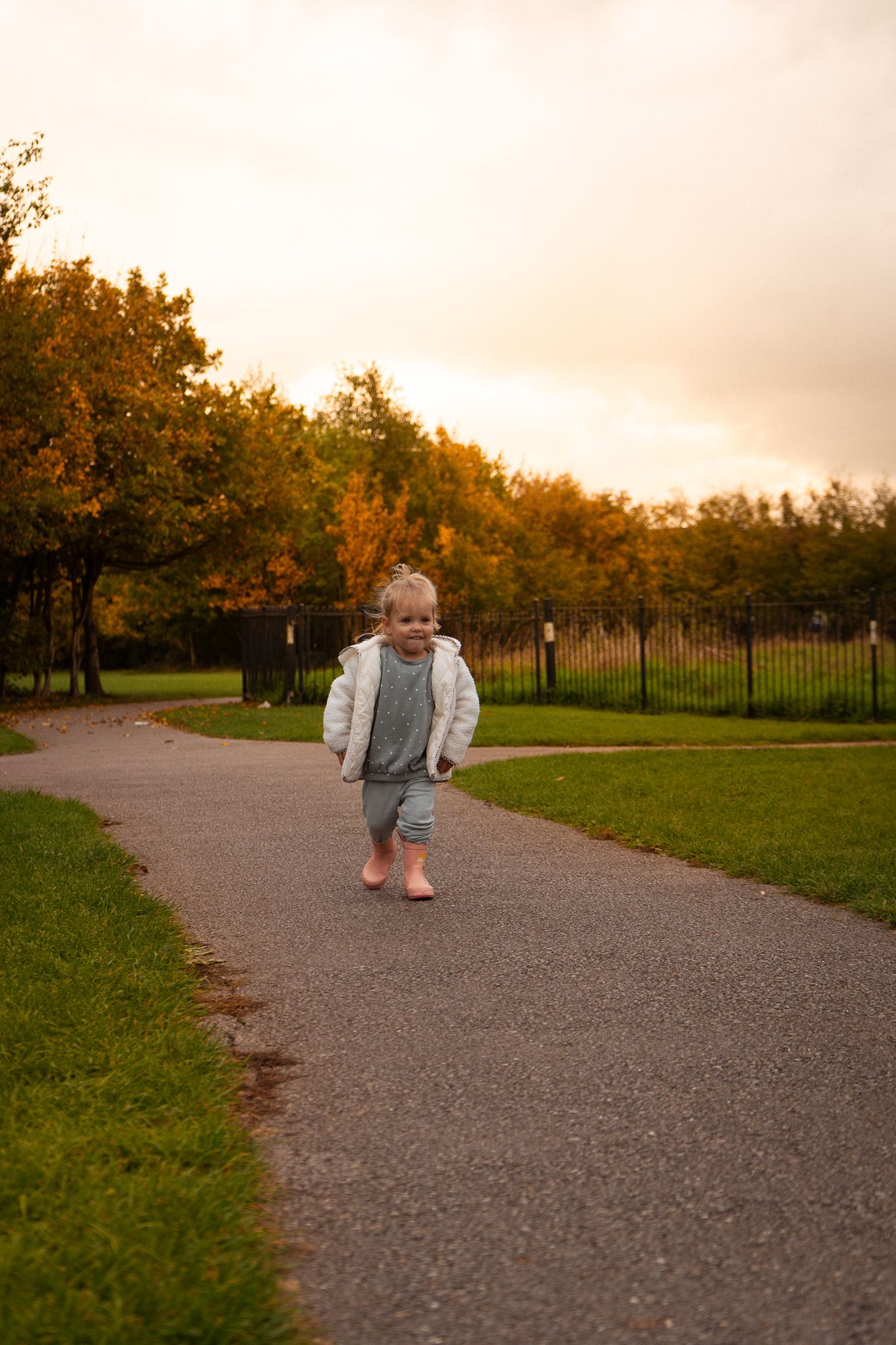 Immy running towards the camera, autnumal tones behind her