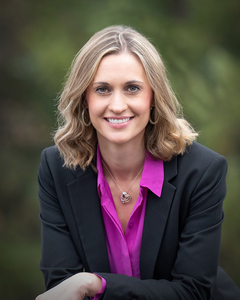 professional executive corporate portrait of a woman in a suit and pink jacket by headshot photographer Luba Wold in Spokane and CoeurdAlene