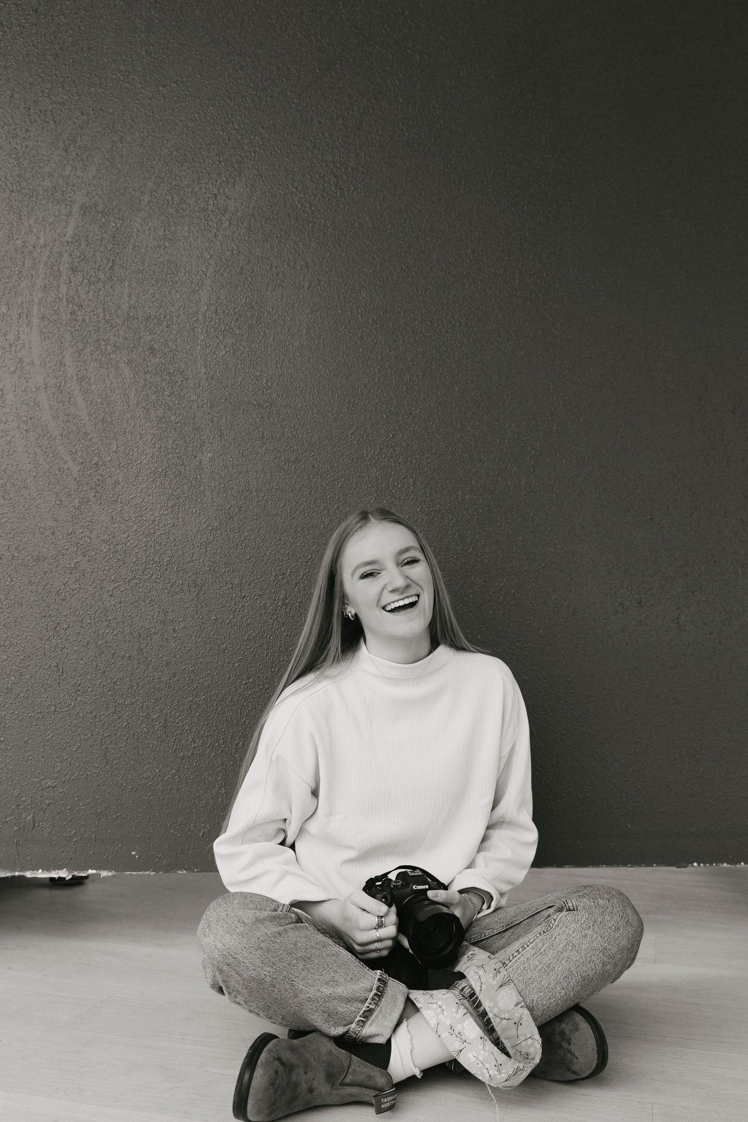 Black and white portraits showing casual poses against a simple studio backdrop.