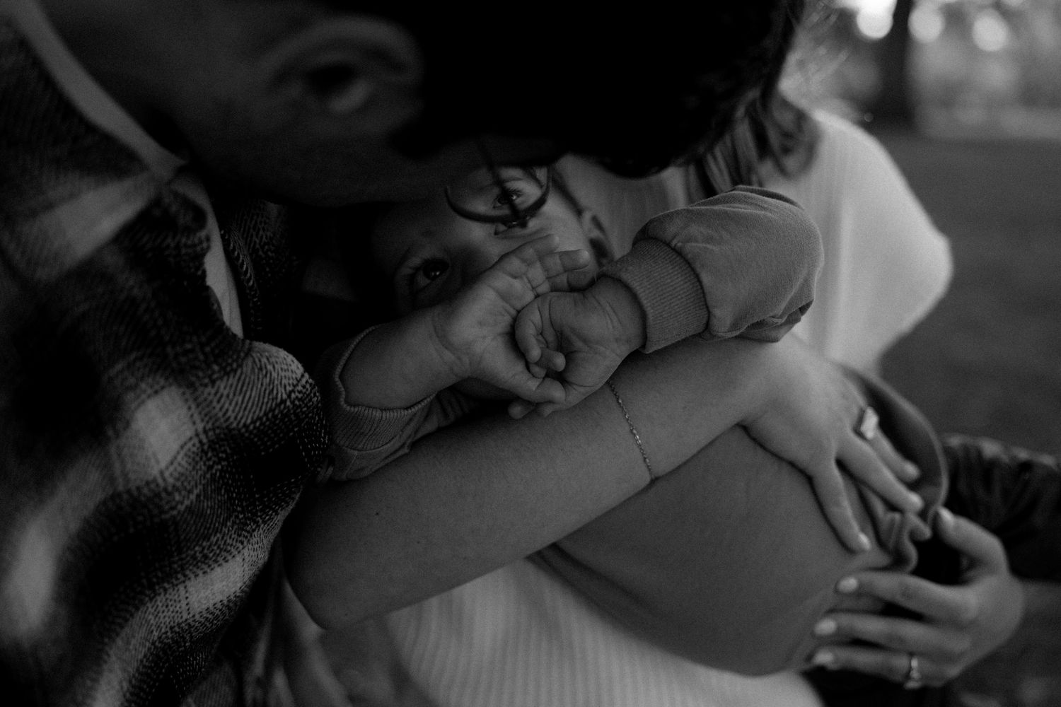 Black and white intimate couple photos arranged in a filmstrip style layout.