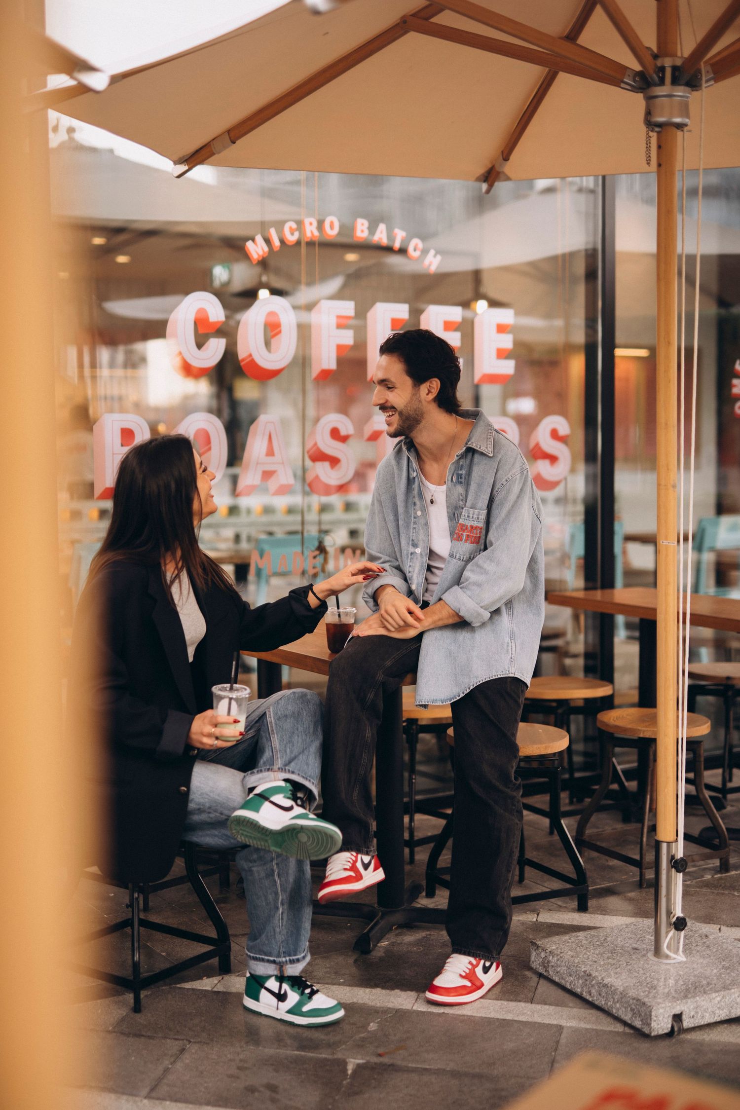A casual coffee shop date outside a micro batch coffee roasters storefront.