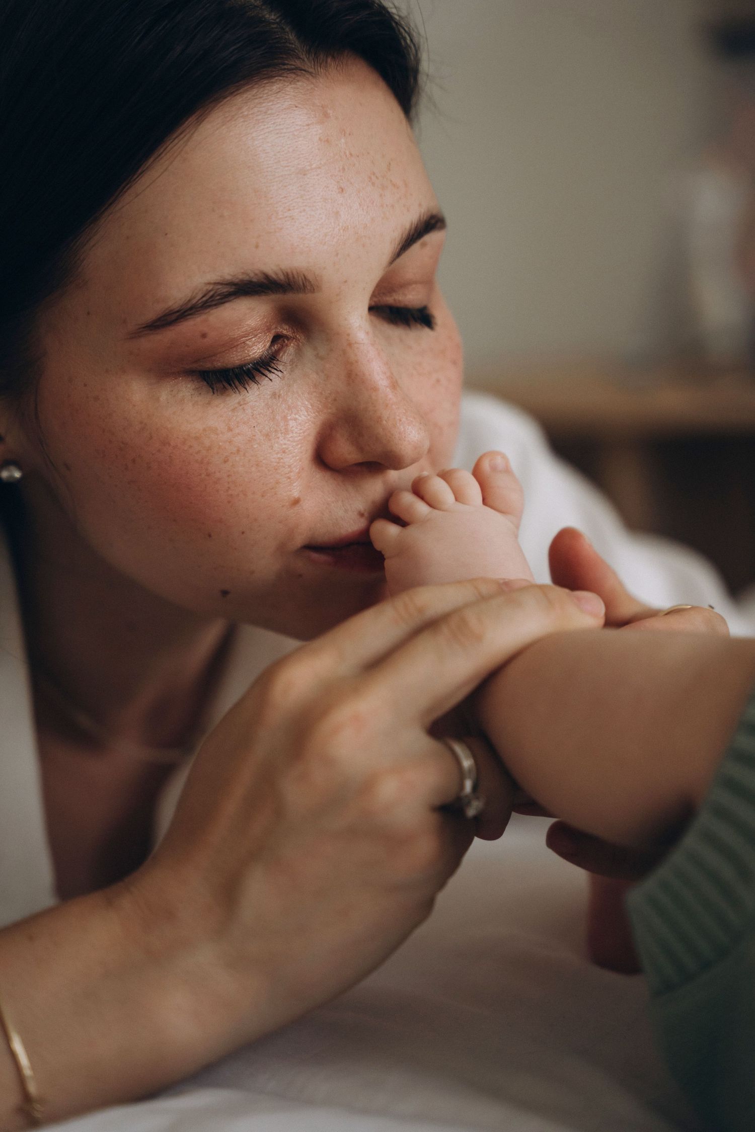 Intimate series of gentle maternal moments with baby's feet.