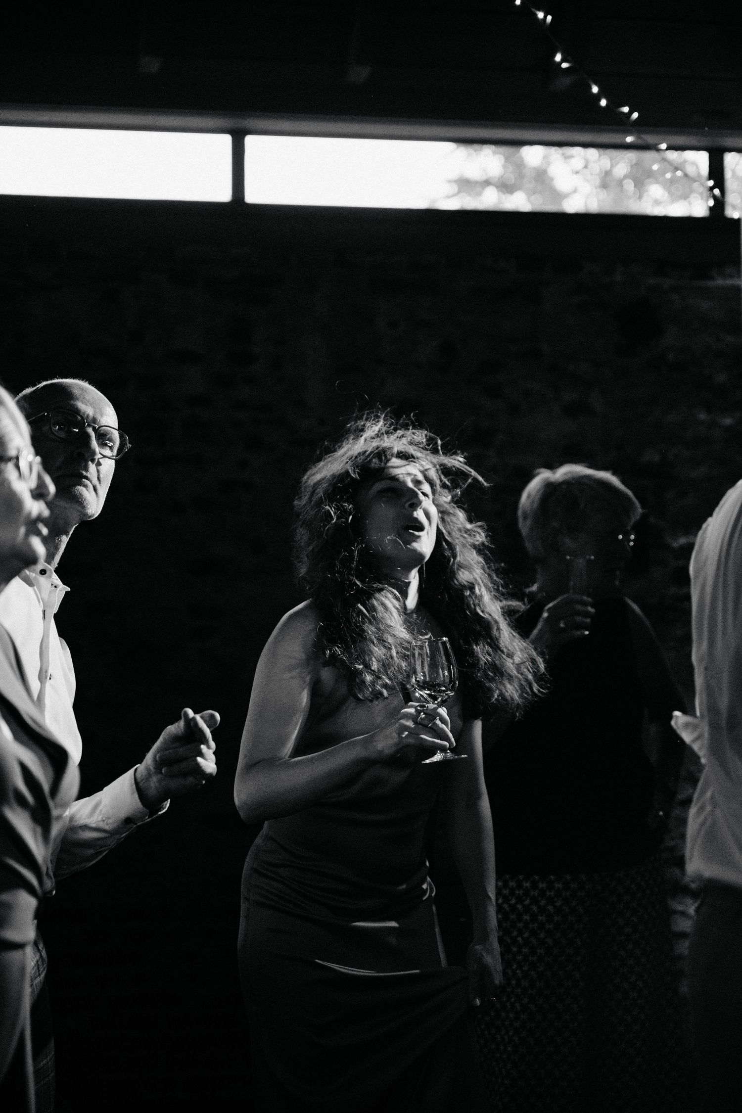 A black and white dance sequence captured in dramatic lighting.
