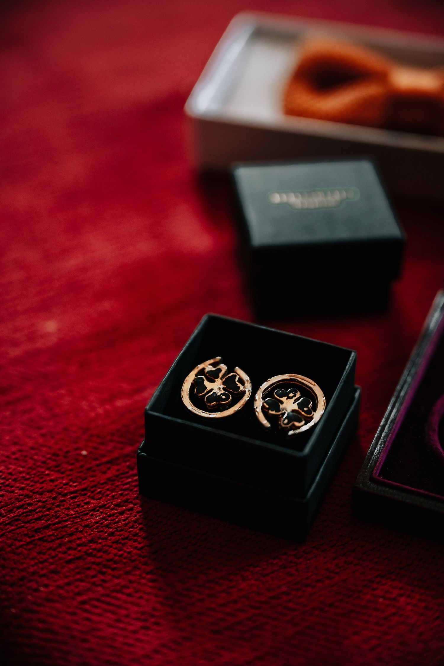 Elegant gold crescent moon and star cufflinks displayed on a deep red velvet surface.