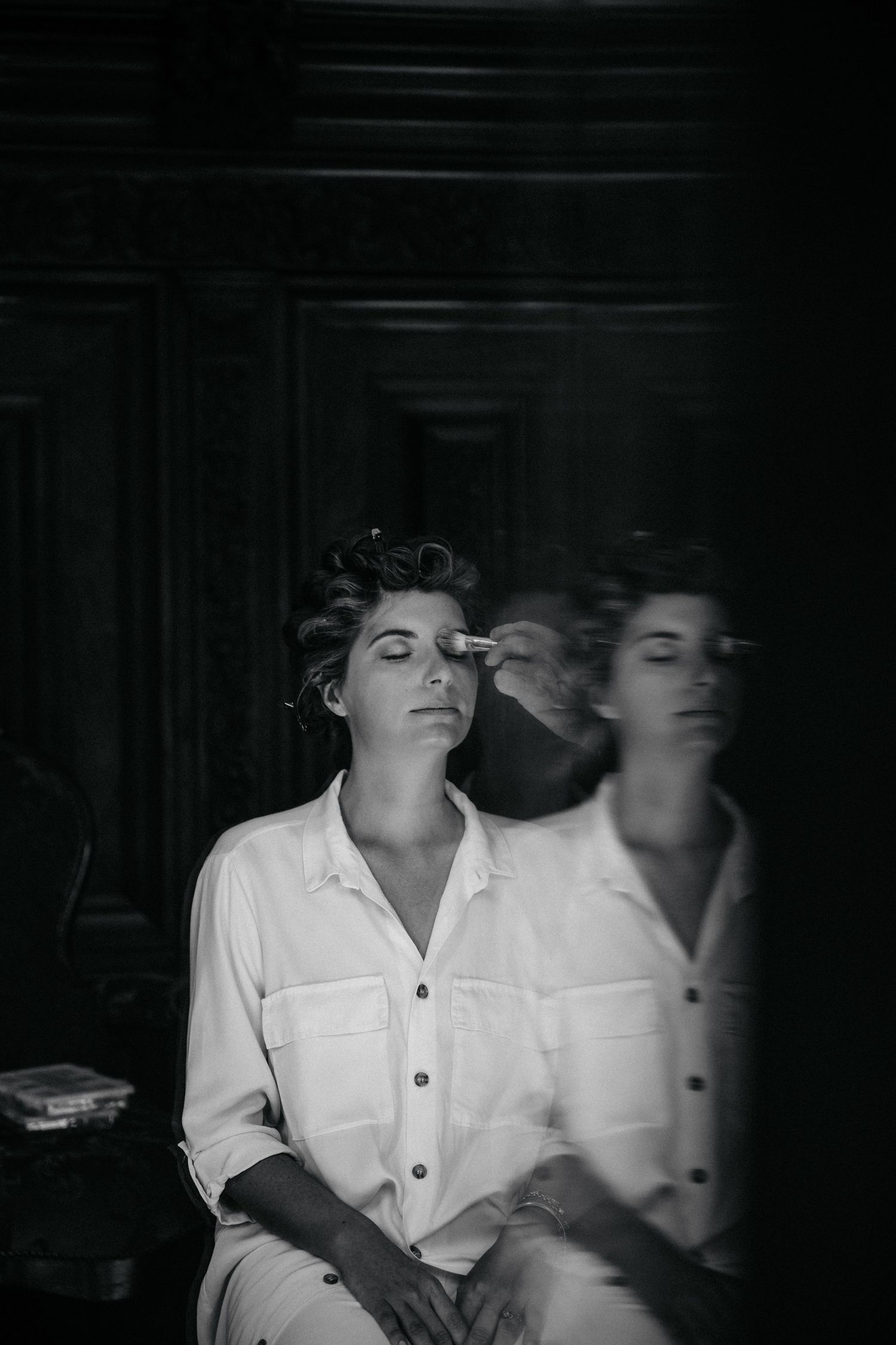 Moody black and white portrait with motion blur creating an ethereal double exposure effect.