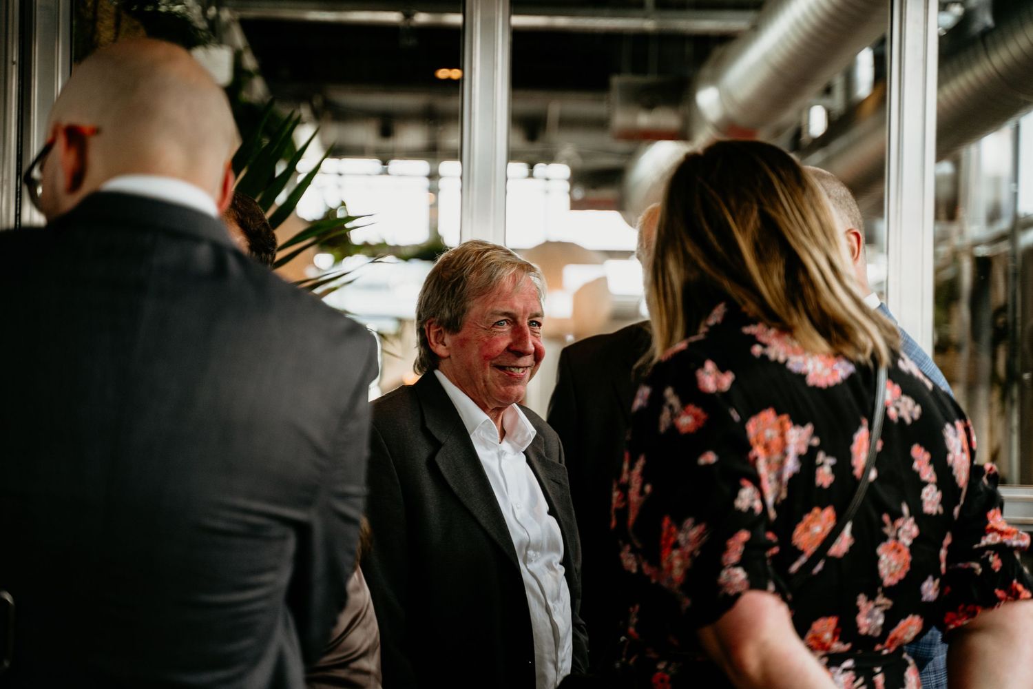 Wedding reception candid moments captured indoors with natural lighting.