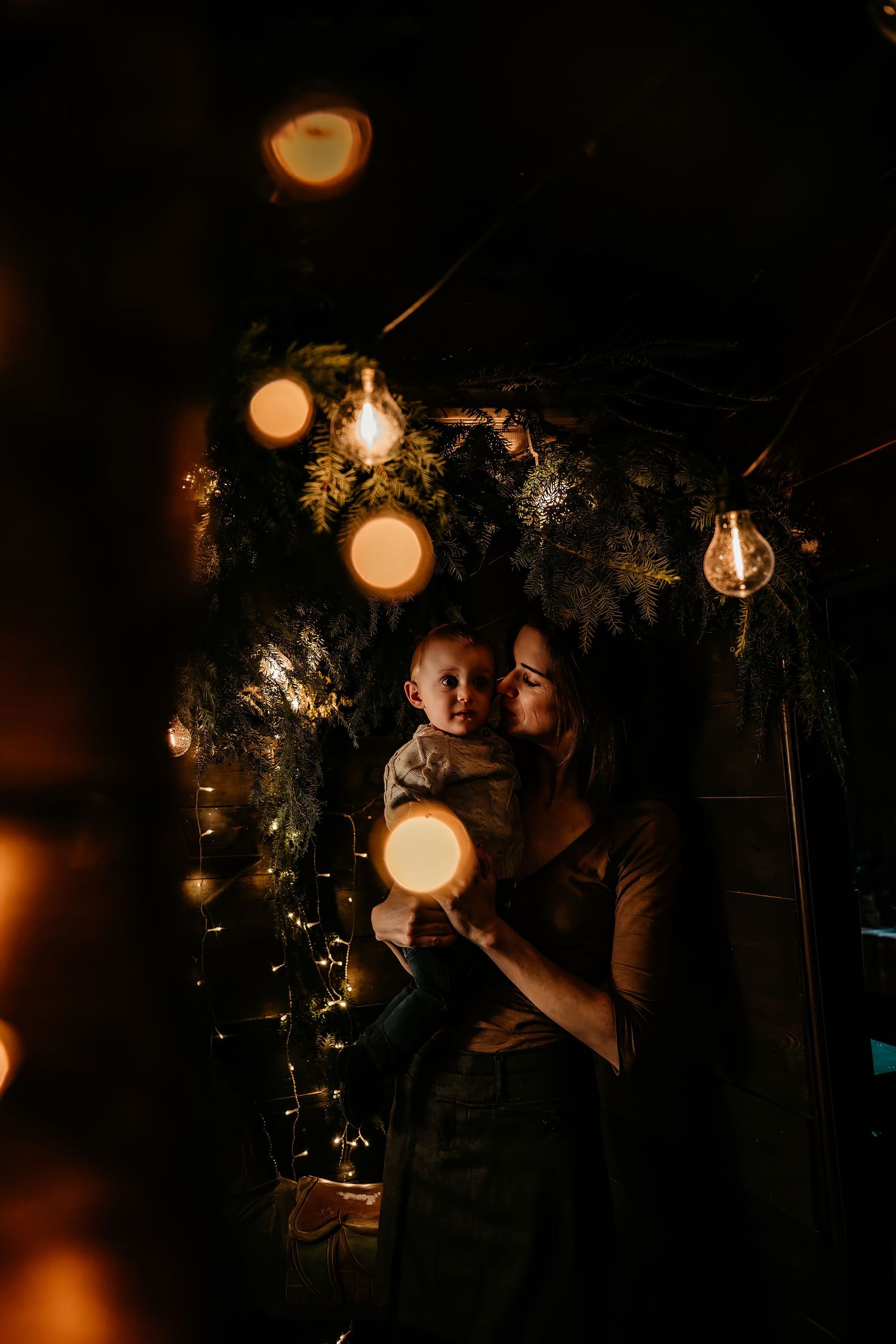 A warm evening scene with string lights and glowing orbs creating a magical atmosphere against a dark background.