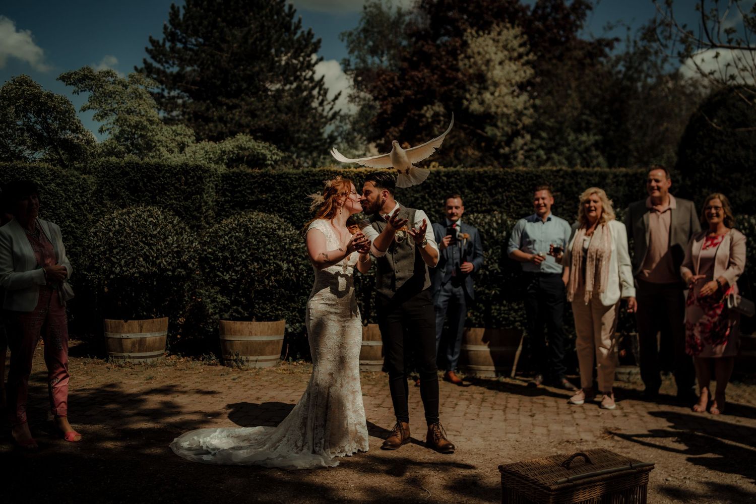 Wedding celebration moment captured in garden setting with natural lighting.