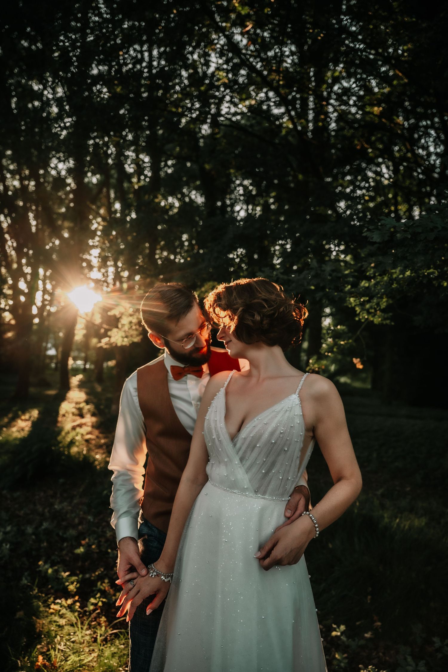 Golden sunset light filtering through trees in a romantic outdoor setting.