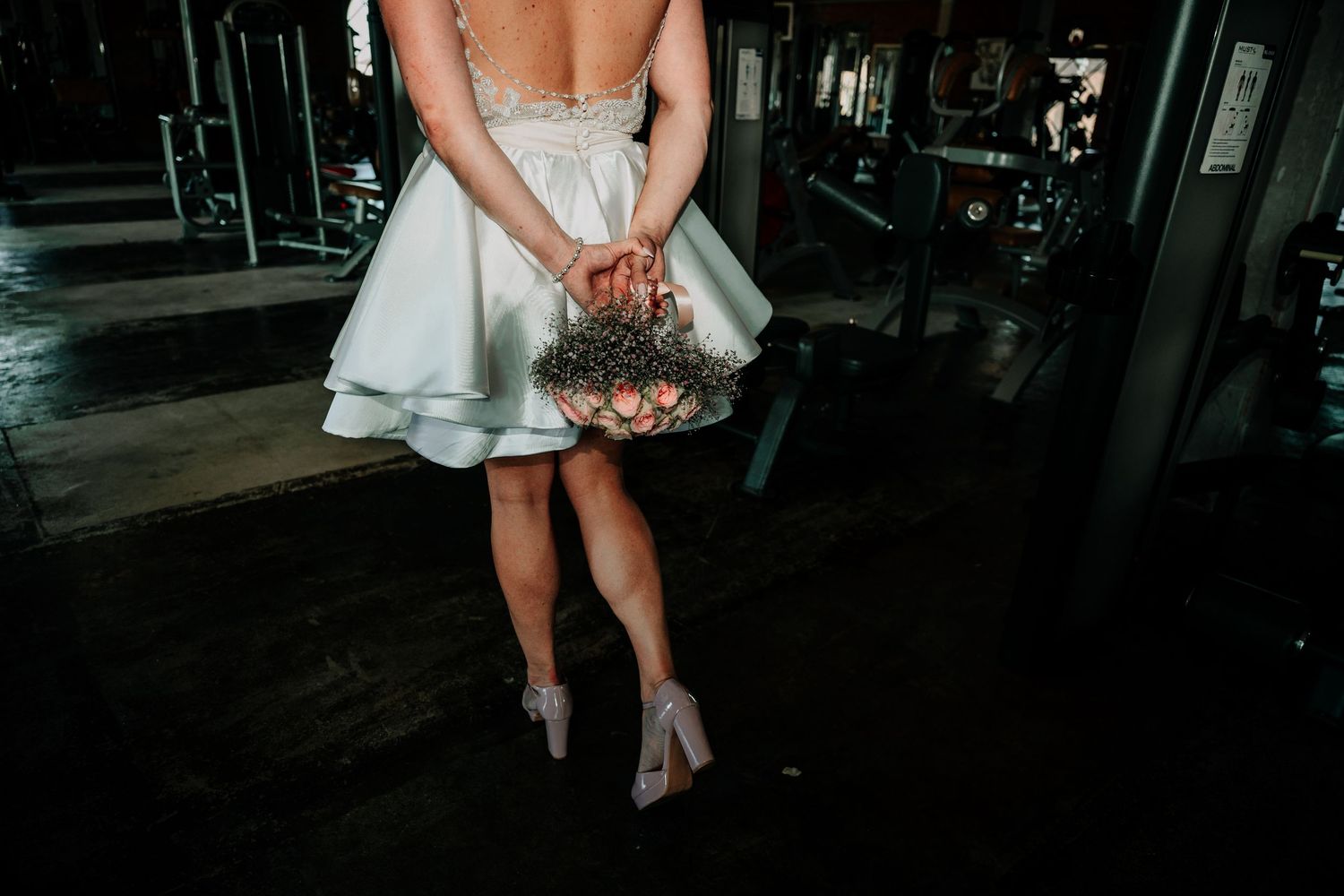 Elegant couple in wedding attire dancing together in a dimly lit venue, shown in multiple romantic poses.