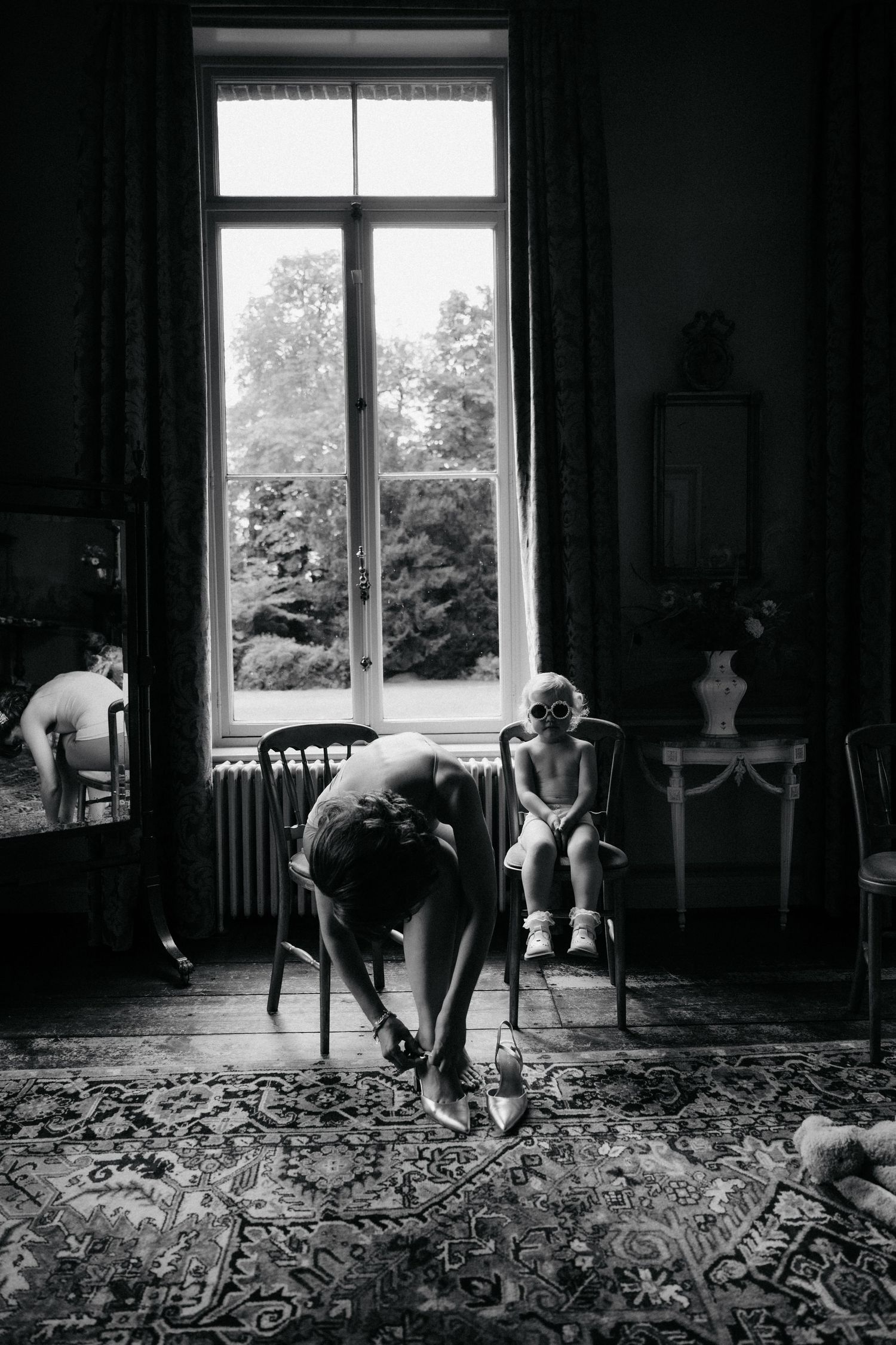 Black and white sequence showing movement across a patterned carpet near a bright window.