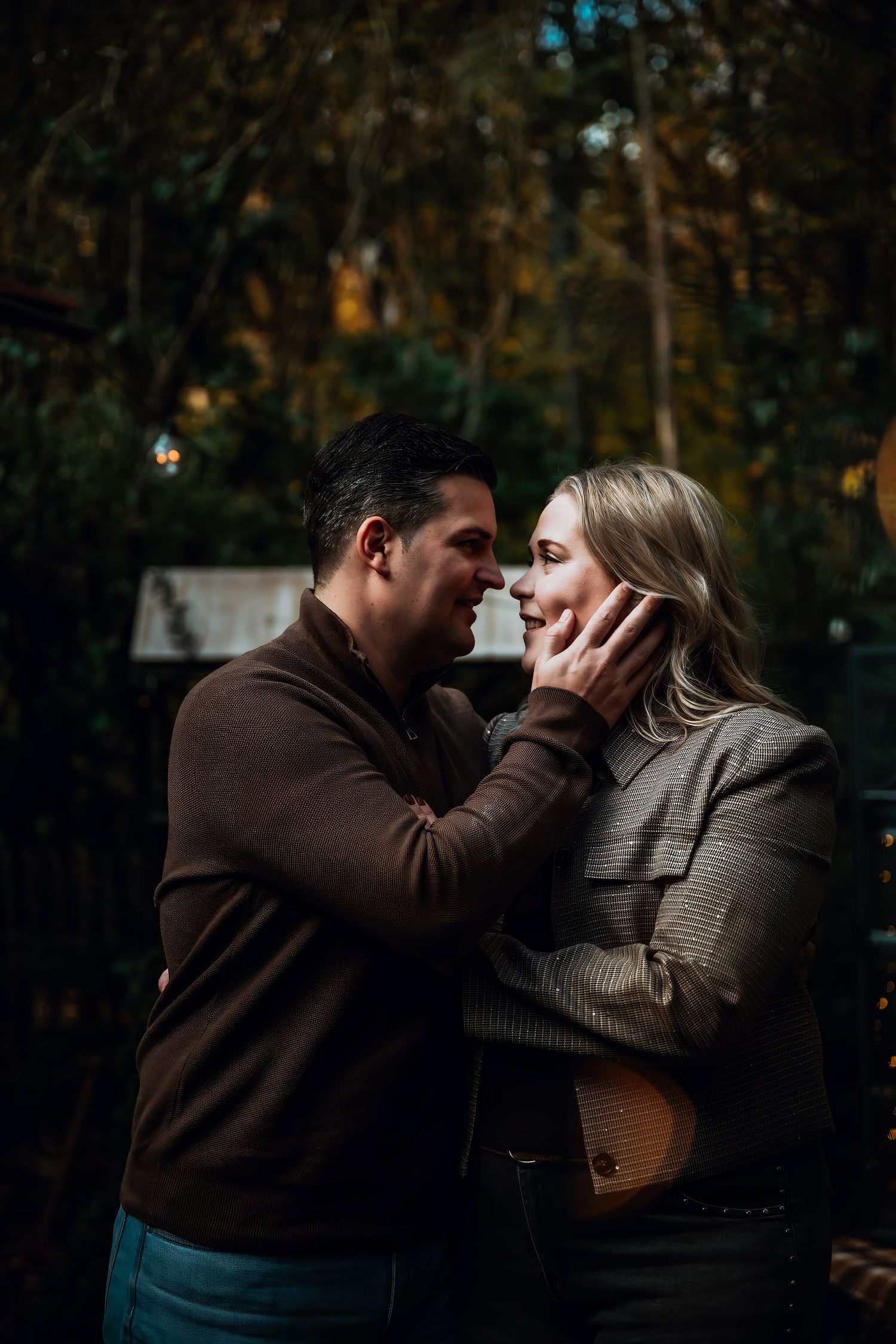A romantic couple shares intimate moments in a series of moody outdoor photos at dusk.