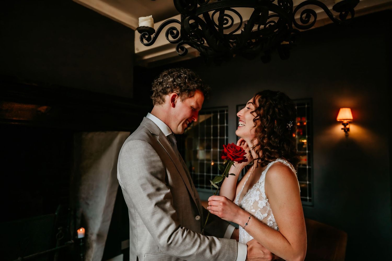 Couple sharing an intimate dance moment in a dimly lit venue with warm ambient lighting.