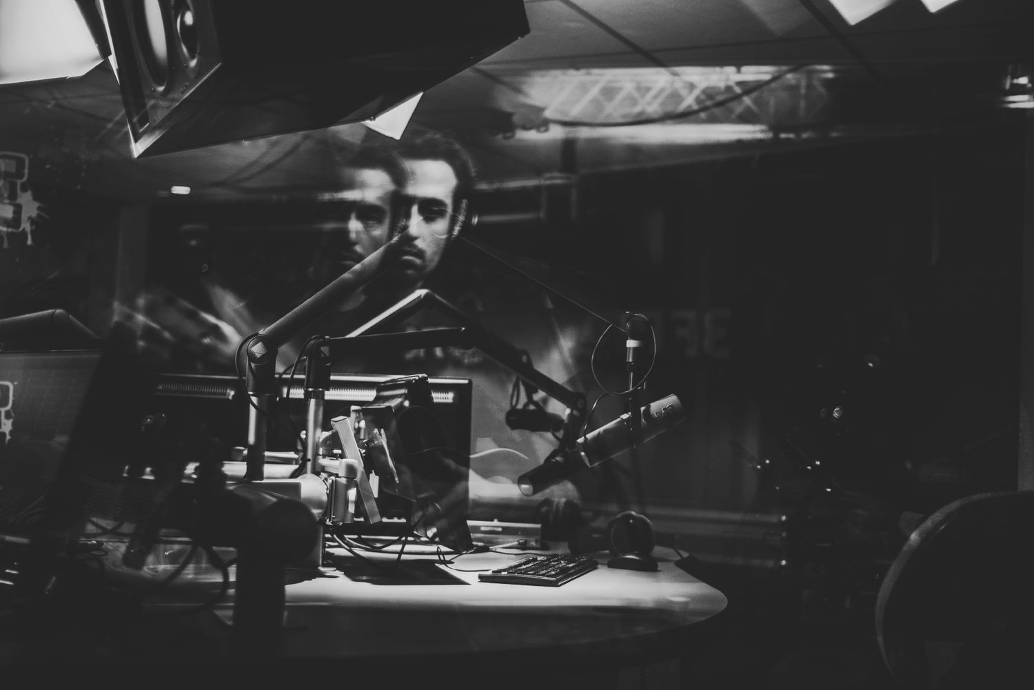 Black and white photograph of musicians performing on stage with dramatic lighting and instruments.