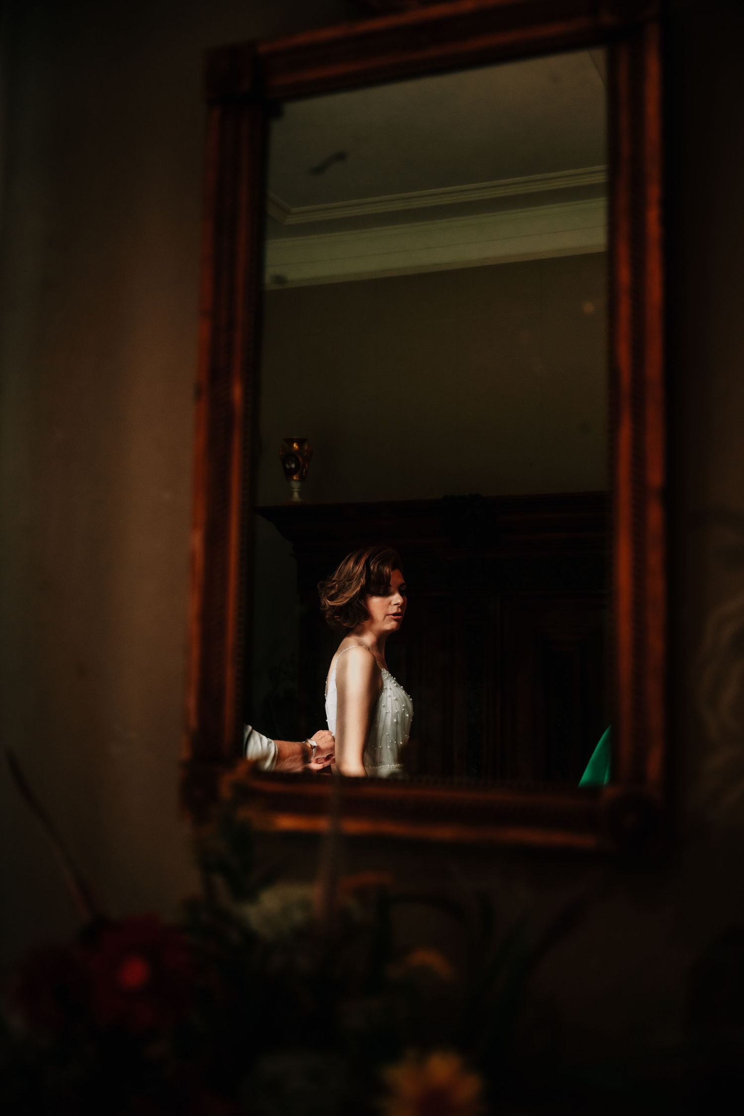 Artistic mirror reflections in a darkly lit interior space creating a mysterious atmosphere.