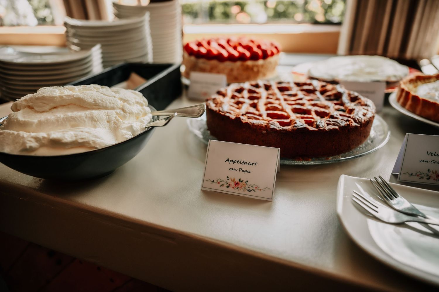 Display of homemade pies and desserts on a rustic wooden table at a wedding reception.