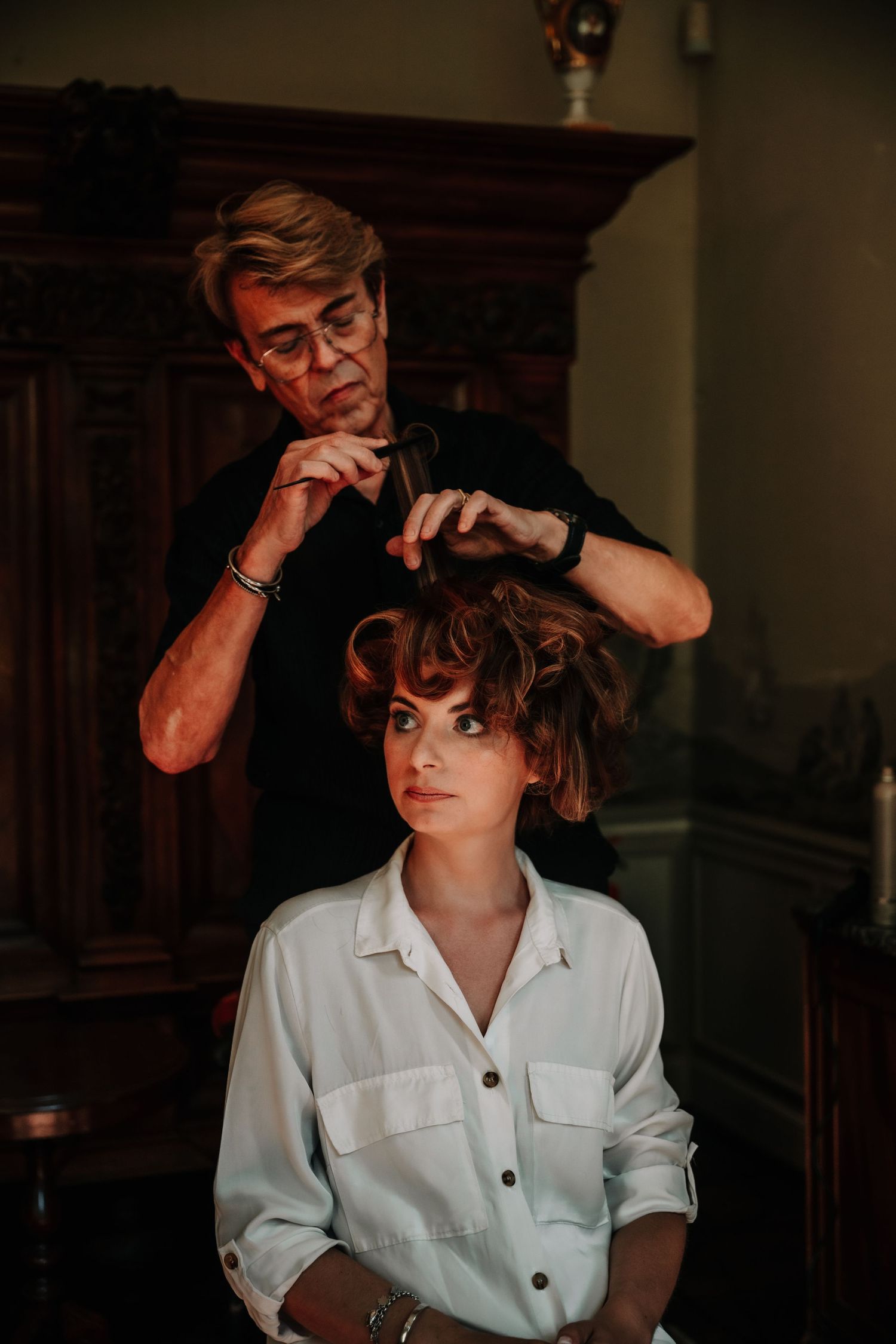 Moody portrait series in white shirt against dark background showing contemplative styling poses.