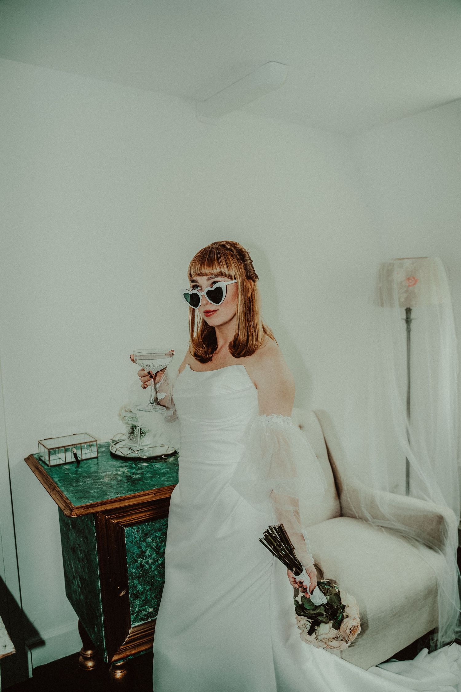A sequence of artistic wedding photos showing a person in a white dress drinking from a glass against a mint green wall.