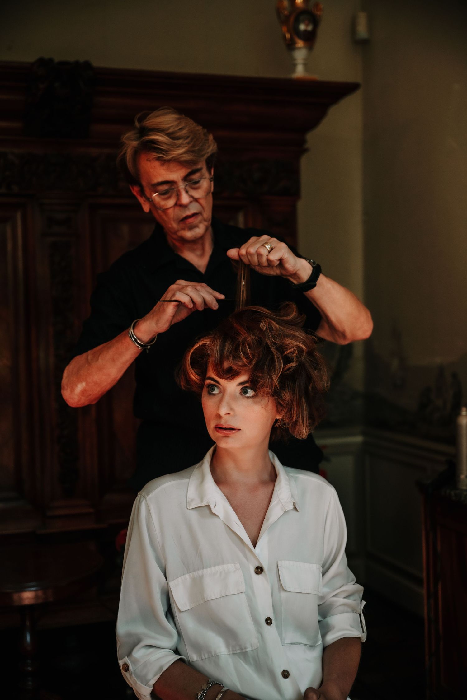 Artistic portrait series with dramatic lighting showing different poses in a white collared shirt.